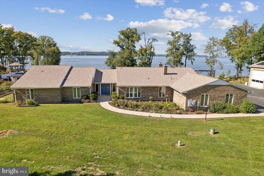 One of a kind waterfront 3,740 square foot all brick rambler located on the Potomac River. This 4 bedroom, 3.5 bath home includes an in-ground pool, 250’ deepwater dock with 2 boat lifts, 2 jets lifts and 300’ of riverfront beach access on 6.58 acres. It has an attached 3-car garage, PLUS a Texas-sized 52' X 62' detached workshop and so much more! The detached all brick workshop has 2 oversized 20' X 14' commercial doors for RVs or boats, plus a side garage bay door with a 10,000 pound car lift. It is also equipped with electric, water, AC and has a full kitchen and bathroom.  
 
This house not only checks all the boxes, but creates a few must haves that you may have not known you needed. It includes designer wallpaper and paint throughout with new LVP floors, designer light fixtures and spectacular views of the Potomac River from almost every room. The formal foyer includes double doors and custom ceramic tile leading into the expansive sunken family room that boasts plenty of space to relax and entertain family and friends. The large dining room connects to the kitchen with 42' oak cabinets, modern appliances, Corian countertops and breakfast nook area with river views as well. The parlor room is fantastic with custom built-in cabinets and stone fireplace. Just beyond the parlor is the bonus room that can be another sitting room, home office, exercise or 2nd family room. The bedrooms are large and consistent with the rest of the home offering plenty of space and detailed design. Owner's suite looks out on the beautiful view of the river. It is spacious with doors leading outside to the pool. It includes double walk-in closets and a newly remodeled bathroom with soaking tub, ceramic tile, double bowl vanity and custom fixtures. 
 
The outside just does not stop. Grill out on the large concrete patio, which stretches across the entire back of the house for endless views. The 20' x 40' pool is fully equipped with a diving board, double gazebos and pool storage house. The property also has a fenced-in terraced garden perfect for flowers and vegetables. There is a very large chicken coop plus a kids playground. In addition, both home and workshop include a new roof and solar panels. This is a once in a generation chance to own your dream home, please set up a tour as soon as you can.
