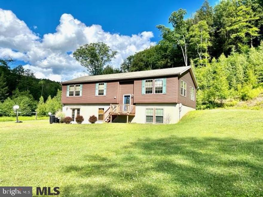 Listen to the sound of the brook and chirping birds while enjoying the seclusion of this home. Raised paneled doors, crown molding, spacious kitchen, central A/C, public water, superior foundation. Wooded acres to roam, large yard for outside entertaining. Lower level is partially finished. Call today for an exclusive tour of this home just miles from town.