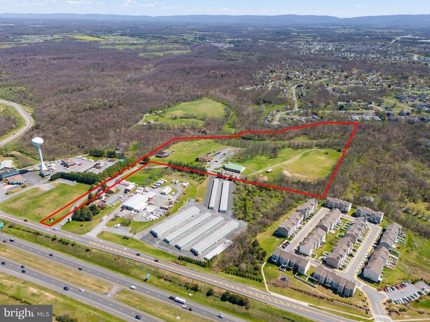 This expansive 29.51-acre property presents a rare opportunity for commercial development in the heart of Frederick County, Virginia. Situated in a strategic location with easy access to I-81, Route 37 and Route 522 via Tasker Road, this parcel is ideal for a wide range of commercial ventures. 

Site consists of a 7000sqft Metal Building currently in use as a church. Finished Basement is approximately 3500 sq ft. Ancillary structures on the site include: 6800sqft 2 Story Log Building with Finished Basement. The building will require some renovations for use, if desired.  The Outbuilding/Barn is most likely a tear down. A portion of the parcel is in a flood zone but will not affect overall use of the site. 

Utilities are as follows: Natural gas ( Washington Gas) , electric (Shenandoah Electric), water, sewer (Frederick County) and high speed internet (Xfinity) are onsite.