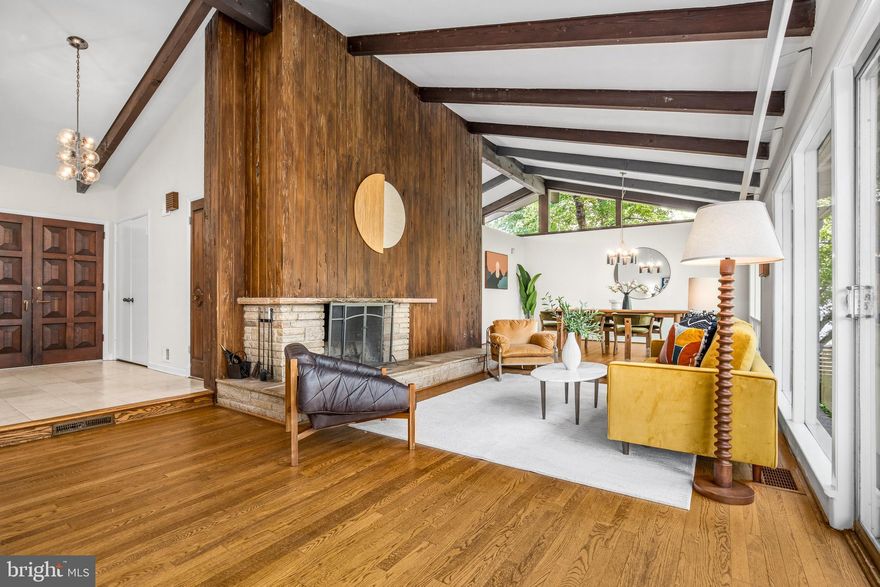 Some homes are built to sell. This one was built to last a lifetime — and it has.

Designed and built in 1958 by acclaimed mechanical engineer Fredrick G. Williams as his own personal residence, 9115 Levelle Drive is a testament to a level of intentional, uncompromising craftsmanship rarely seen today. Every proportion, sight line, and material choice reflects the vision of a man who knew exactly what he was doing — and who was building not for the market, but for his family. Now offered for only the second time in its history, this is a once-in-a-generation opportunity to steward a true original.

Set on nearly an acre (.89 acres) in one of Chevy Chase’s coveted enclaves and positioned at the end of a quiet dead-end street, the property unfolds with a sense of privacy and arrival. Mature trees and gardens — lovingly tended over decades — frame the home and yard,creating beauty across every season.

The architecture is quintessential mid-century modern: clean horizontal lines, an effortless connection between interior and exterior, and an atmosphere of calm, purposeful elegance. Expansive floor-to-ceiling windows flood the home with natural light and draw the landscape in, reinforcing the sense of openness and retreat. At the heart of it all, a monumental fireplace surrounded by Pecky Cyprus wood which commands the main living space — the kind of architectural anchor that draws people together and defines a room. It isn't a feature. It's the soul of the home.

With five bedrooms and three full bathrooms and over 3900 square feet, the layout is as generous as it is thoughtful. The main levels offer gracious, light-filled living, while the walk-out lower level opens up an entirely separate world of possibility: two generous bedrooms, a full bathroom, a sprawling family room, a dedicated office, and a laundry room — with room left over to imagine. Guest suite, au pair quarters, creative studio, or home gym — the lower level adapts to the life you want to live.

Outside, a swimming pool anchors the rear grounds, inviting long summer afternoons and effortless entertaining surrounded by the privacy of tall trees and mature plantings. A two-car carport and additional driveway provide ample, easy parking — practical notes to a property that has thought of everything.. Overlooking a green lawn rather than a street, the only passersby are on foot or bicycle.

To own 9115 Levelle Drive is to join a remarkably short line of custodians — just two families before you. The stories held within these walls, the care layered into these gardens, the integrity engineered into every beam: all of it passes to you.

Homes like this don't come back around. This one is ready for its next chapter.