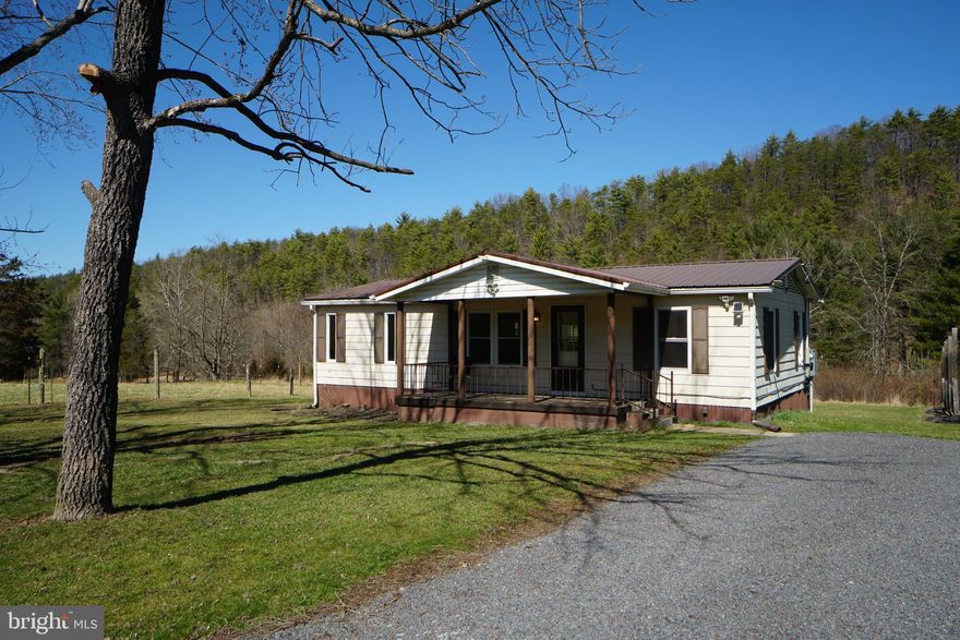 Great little Rancher on level lot in beautiful country setting. Perfect spot to put down permanent roots or a wonderful place to escape from city life. Enjoy the view from the back deck where the only lights you'll see at night will be a sky full of stars.  Garden area, Well water, 200 Amp Service and 30 KW Auto-Start Generator. Small creek runs through property.