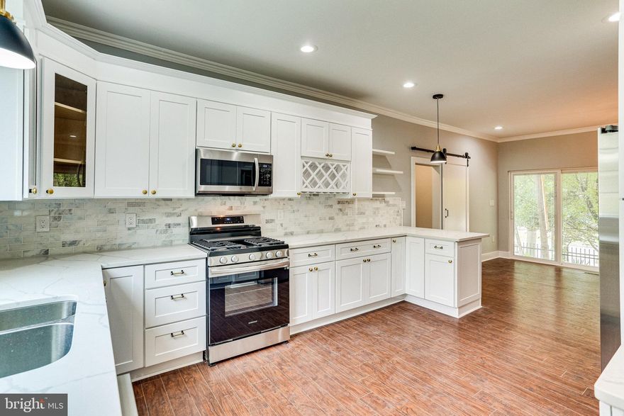 Multiple Offers Received! Impeccable renovation in the heart of Riverdale! This is a circa 1903 Victorian that has been renovated and rebuilt. The house sits on a spacious corner lot in the heart of Riverdale Park between the Arts District shopping and Riverdale Park Station. WALK to MARC station (1 stop to Union Station, DC), Town Center Market, shops and eateries, and walking path to Whole Foods and restaurants at Riverdale Park Station.  The home itself boasts a brand new roof, brand new windows, brand new siding, brand new hvac, brand new plumbing.  The home is massive, it has three bedrooms upstairs. The master bedroom has a walk-in closet and it’s own full bathroom.  The main level has two extra rooms that can be used for two home offices and it has a full bathroom. It has a huge open layout kitchen with brand new appliances and a barn door separating the offices from the rest of the home. The basement has another full bathroom and an open layout for a home gym, family room or kid’s play room. The home has been professionally landscaped and has a wrap around porch. Sits on a huge corner lot with an entrance at each corner of the road. Agent has financial interest in property.