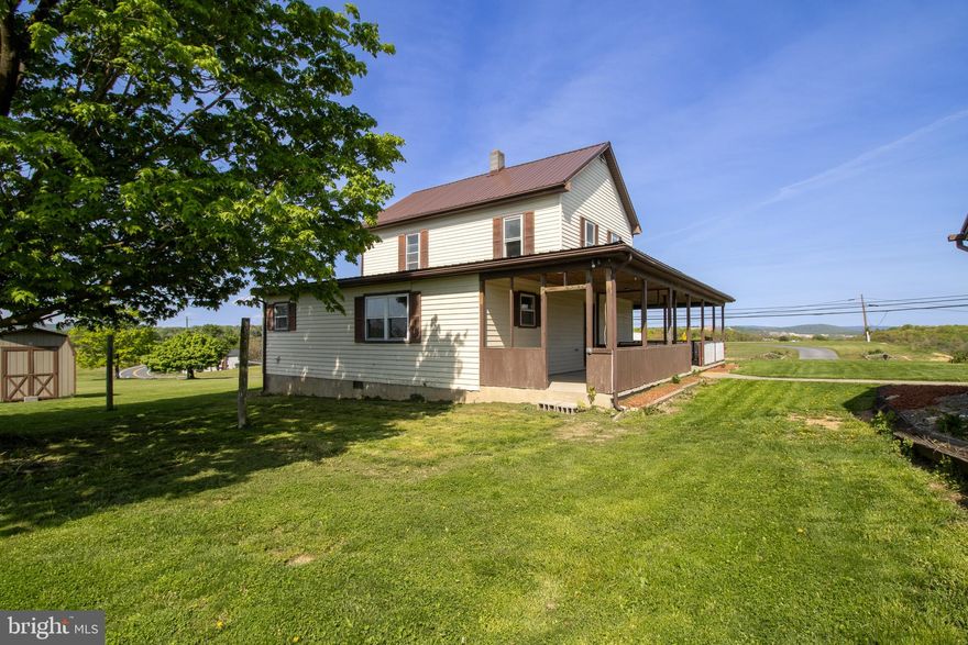 If you like large covered porches then this is the house for you!  Nice views from both porches on this country home.  Living, dining, kitchen and an additional family room on the main level.  Full bath and a half bath on the main level as well.  Upstairs are three bedrooms and another half bath.  A large detached garage type building could be completed as a business or another living quarters.