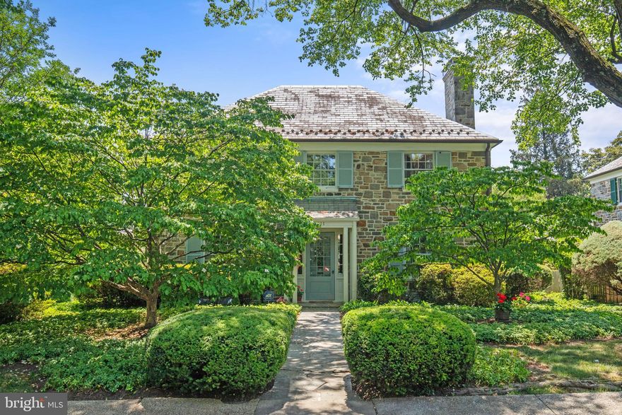 Located on a picturesque street in Historic Homeland, buyers will fall in love with this enchanting 4 bedroom stone colonial with 2 car garage.  The traditional main level floor plan features a living room with hardwood floors, wood burning fireplace, and opens to a private stone patio.   The bright dining room is highlighted with a large bay window and hardwood floors, and leads to an updated kitchen with quartz countertops, stainless steel appliances, under cabinet lighting, and breakfast area.  A charming screened porch off of the kitchen is the perfect retreat for outdoor dining or just to enjoy the summer!  Main level also has updated half bath.  Upper level includes 4 spacious bedrooms, two renovated baths and hardwood under carpet in hallway.  The primary bedroom has attached bath, walk-in closet, and hardwood floor (under carpet).  Renovated hall bath is dual entry.  Lower level is partially finished with recreation room, wet bar, and half bath, and the unfinished area has plenty of room for storage.  Beautifully landscaped with stone walkways and patios on both sides of the house.  Welcome to 111 Croydon Rd!