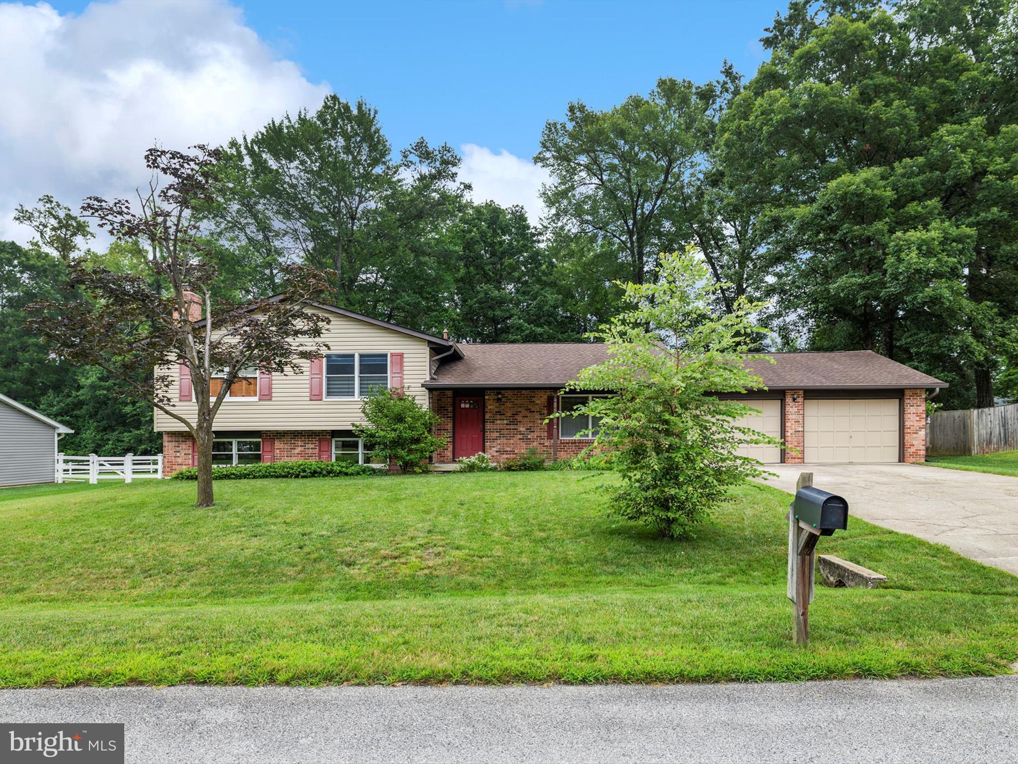 LET’S TALK ONE-OF-A-KIND!
Set on nearly half an acre in Glenn Dale, this split-level offers a rare combination of residential comfort and serious workspace. Inside, you'll find 3 bedrooms, 2.5 baths, upgraded flooring, a light-filled kitchen with breakfast area, and a separate dining room. The lower level includes a rec room with a decorative brick fireplace, half bath, laundry, utility space, and walk-up stairs to the backyard. Bonus: the roof and siding were replaced in 2016.
What truly sets this one apart:
A 26’x28’ attached garage with 10' doors, paneled insulated walls, and two attic access points with decked storage — plus a 40’x28’ detached garage with two oversized bays, workshop space, in-wall gas heat, attic storage, and a concrete pad out front. Additional outbuildings include a 12’x18’ run-in shed, an 8’x12’ greenhouse, a 36’x12’ lean-to with bluestone flooring, and even a tree house.
The backyard is fully fenced, level with tree-lined views along the back.
If you're looking for a property that is not part of an HOA and with room to build, store, create, or tinker — both indoors and out — this one delivers.