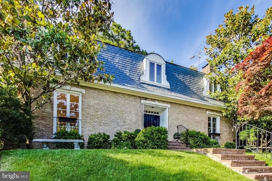 This elegant French Pavilion style home is ideally located within DC's Northwest" Foxhall" neighborhood and is a perfect place to host the finest of Washington's gatherings while serving as a comfortable family home.  Features include hardwood floors, spacious reception rooms, and a manicured back yard with newly opened in- ground pool.  The traditional floor plan offers a formal living room with gas fireplace and French doors overlooking the backyard & pool as well as a separate dining room suitable for entertaining on a grand scale.   A gourmet kitchen offers an optional breakfast nook and connects with another sitting room with built-in bookshelves which is perfect as an office/study or casual family room.  Walk up the curved staircase to the second floor boasting 3 bedrooms and 3 full bathrooms including the primary suite with fireplace. The renovated primary bathroom has a spa-like feel with a walk-out balcony overlooking the pool.  The second and third bedroom are each en suites with their own private full baths.  The lower level is suitable for use as a guest or in-law suite with a kitchenette, living area, and spacious bedroom.  The large 2 car garage includes a utility workspace with built-ins.  A dream backyard with pool and lounge area offers a tranquil place to relax in privacy with the completely fenced yard that backs to expansive private wooded grounds.   Nestled among embassies, universities and The Washington Lab School, this home is also just a few steps to  Foxhall Park and a short distance to DC's finest retail and dining scene of MacArthur Blvd, Georgetown, and Wisconsin Ave.  With easy access to DC's major commuter route & National airport, this premier location cannot be beat!