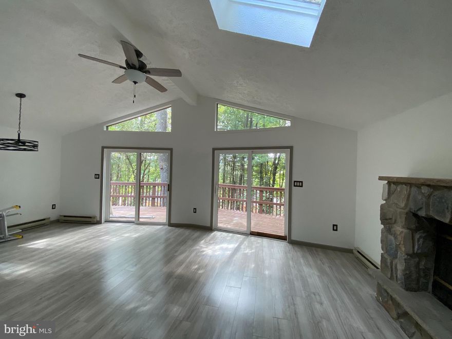 Welcome home to this perfectly renovated raised ranch. Featuring a with a wrap-around terrace, extending out of the open floor living room. Stone mantel fireplace to heat up the home.  Walkout basement with  a potential for an additional living space, 2 bedrooms and bathroom. Brand new gorgeous kitchen with Samsung stainless steal appliances.  New bathroom, and new flooring throughout this home. Located in an amenity filled community offering Pool, Lake, Clubhouse, Basketball/Tennis Courts, Central Water System & Garbage Drop-Off Area! Close To shopping centers, dining, skiing, fishing,  and major highways. This home comes with a full 1 year home warranty at time of closing.