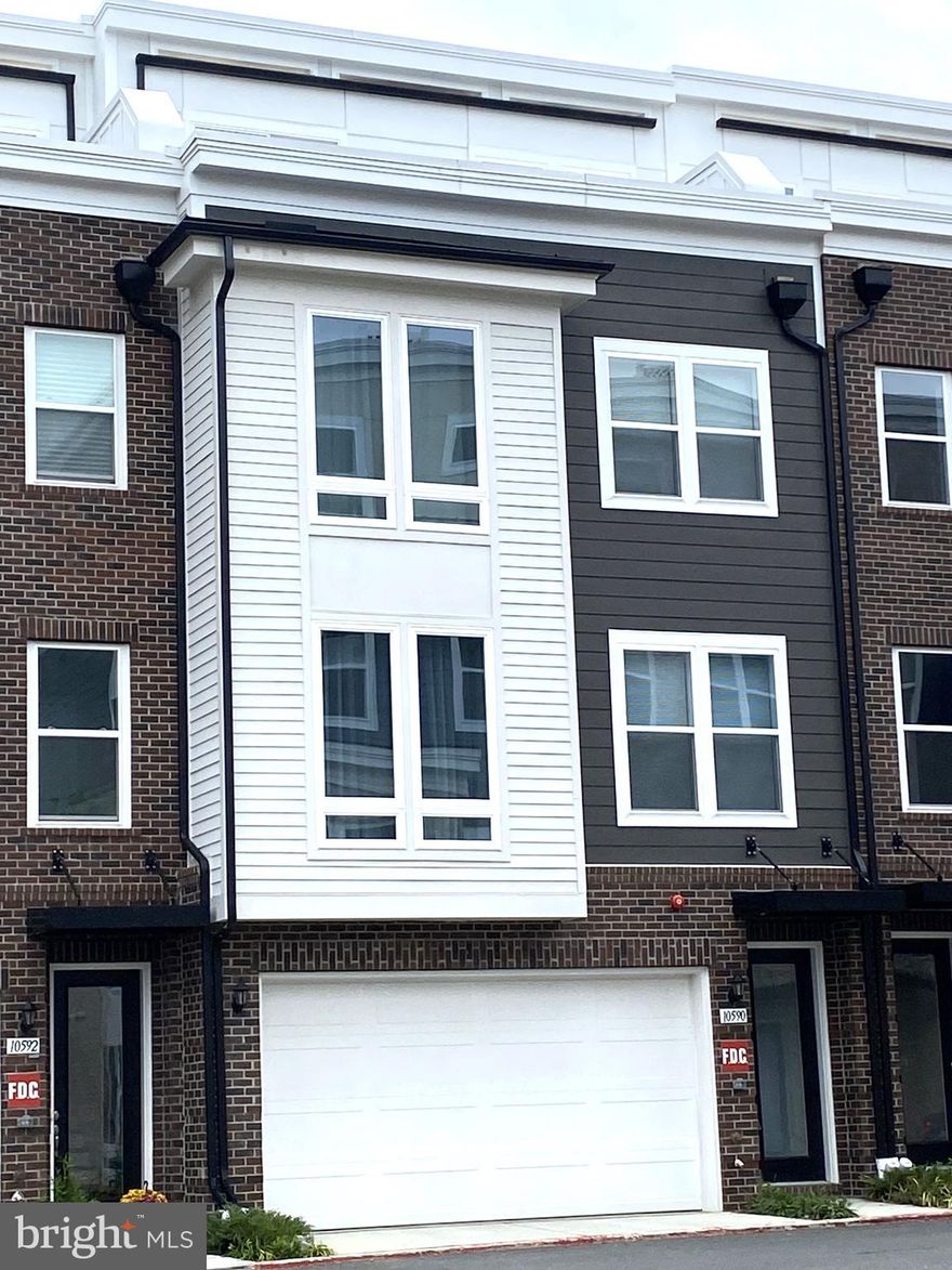 Brand new never lived -in 4-level luxury townhouse completed in 2025 with rooftop terrace and approximately 3,246 square feet of modern living space with 9' ceilings on every level. This light-filled home features 5 spacious bedrooms, 4 full baths, and 1 half bath, thoughtfully designed to combine style, comfort, and functionality.

The entry-level offers a welcoming rec room, a private bedroom with a full bath, and access to a 2-car garage equipped with a “Smart” garage door opener, keypad, and remotes.

The main level boasts an open-concept layout with a gourmet kitchen at the center — complete with a large island, upscale quartz countertops, stainless steel Electrolux appliances, 42” cabinets, and a pantry with ventilated shelving. The kitchen flows seamlessly into a spacious great room that opens to a private deck overlooking an open field — a perfect spot for morning coffee or evening relaxation. A generous dining area and a powder room complete this level.

Upstairs, the third floor includes a luxurious primary suite with two walk-in closets, an ensuite bathroom featuring a walk-in shower and double-sink vanity. Two additional bedrooms, a full hallway bath, and a convenient laundry room equipped with efficient washer and dryer round out this level.

The top floor features a versatile loft space, an additional bedroom and full bath, and access to a rooftop terrace — ideal for entertaining or simply enjoying the views.

Additional upgrades include luxury vinyl plank flooring throughout all common areas and upgraded carpet in all bedrooms. All bathrooms are finished with elegant quartz countertops.

Tucked away in a location offering easy access to major transportation venues including I-66, Route 123, Route 50, and Route 29, as well as the Vienna/Fairfax-GMU Metro station, residents of this townhome will enjoy an uncommon blend of convenience and serenity. Just minutes away is downtown Fairfax, George Mason University, and an abundance of shopping, dining, and entertainment options.

This townhouse offers both space and sophistication, ideal for modern living. Don’t miss the opportunity to make it your home!