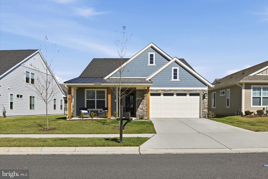 Welcome to 55+ living at its finest in the sought-after Lake Frederick community—where quality shines both inside and out. This like-new Craftsman-style home, built in 2023, offers the perfect blend of luxury, comfort, and effortless main-level living.

From the moment you arrive, the charming fiber cement exterior sets a warm and sophisticated tone. Step inside to a thoughtfully designed, light-filled layout featuring stunning hardwood flooring and high-end finishes throughout.

The gourmet kitchen is a true centerpiece, boasting abundant cabinetry, a massive island ideal for gathering, and a spacious walk-in pantry sure to impress any home chef. The adjoining dining area flows seamlessly to a custom patio—perfect for indoor-outdoor entertaining—while the inviting family room features a cozy gas fireplace.

The main-level primary suite is a private retreat, complete with a spa-like bath featuring a large walk-in shower with bench seating, dual vanities, and a generous walk-in closet. A second bedroom, full bath, and a private office with glass doors complete the main level.

Upstairs, you'll find a versatile loft space, an additional spacious bedroom with a walk-in closet, and a beautifully designed full bath—perfect for guests or extended stays.

Additional features include a spacious two-car attached garage with excellent storage, a concrete driveway, a sprinkler system, an EV charging station, and an invisible fence with two collars. The 0.14-acre lot provides the perfect balance of outdoor space to enjoy.

Beyond the home, enjoy resort-style community amenities including a stunning pool with heated, indoor, and saltwater options for year-round enjoyment. The beautifully maintained grounds encourage leisurely walks and social connections, creating a true sense of community.

This is more than just a home—it’s a lifestyle. Experience the perfect balance of modern elegance and relaxed living in Lake Frederick. Your next chapter starts here.