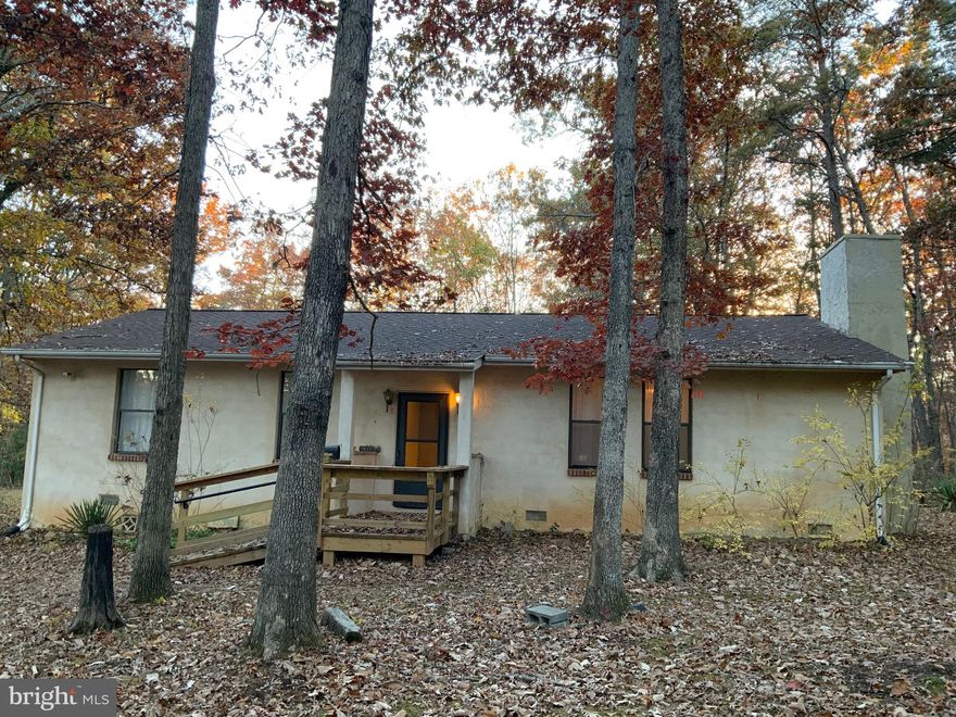 Large Rambler with 5 ACRES Lovely LAND, Level and Privacy!   Featuring appx  1479 SQ FT! Country Kitchen!  Large Step down family room with brick fireplace &  2 wood decorative wood boxes.  TALL CEILINGS! 3 ceiling fans, w/w carpeting, washer & dryer convey. Primary bedroom with double closet/adjoined to front coat closet.  2nd bedroom could use closet on other side.  Large full bath and wide hallway.  Roof, replaced 2017.  Outbuilding/Shed conveys.  Sold  in "as is" condition.  Well constructed home...a Diamond in the rough, bring your vision & ideas.  Zoning A-3.