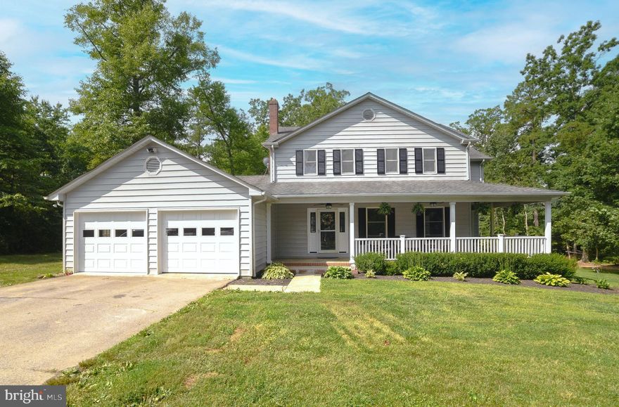 This colonial style home with a wrap around front porch is situated on 3.26 wooded acres. Located in Leonardtown and just 11 miles from NAS Pax River, this home provides the best of both worlds - convenience and quiet country living! Walking through the front door, you are greeted by beautiful Brazilian Cherry hardwood floors which carry throughout the main living level. This homes spacious floor plan seamlessly flows from the formal living room just off of the foyer, through to the formal dining room which features french doors that lead out to the front porch and a bay window with a custom built in bench. 
The kitchen with granite countertops and adjoining breakfast room with sliding glass doors open up to a new composite deck overlooking the tree lined back yard. The main level also features a great room just off the breakfast room with vaulted ceilings and a brick hearth fireplace. Abundant storage with lots of closet space, large laundry/mud room and in the 2 car garage with storage above. Upstairs this home has 4 spacious and bright bedrooms with ample closet space and 2 full bathrooms. Located within Piney Point Elementary, Leonardtown Middle and Leonardtown High School Districts. Recent Updates include: brand new BAT septic system, garage doors, garage insulation and drywall, front porch columns and railings.