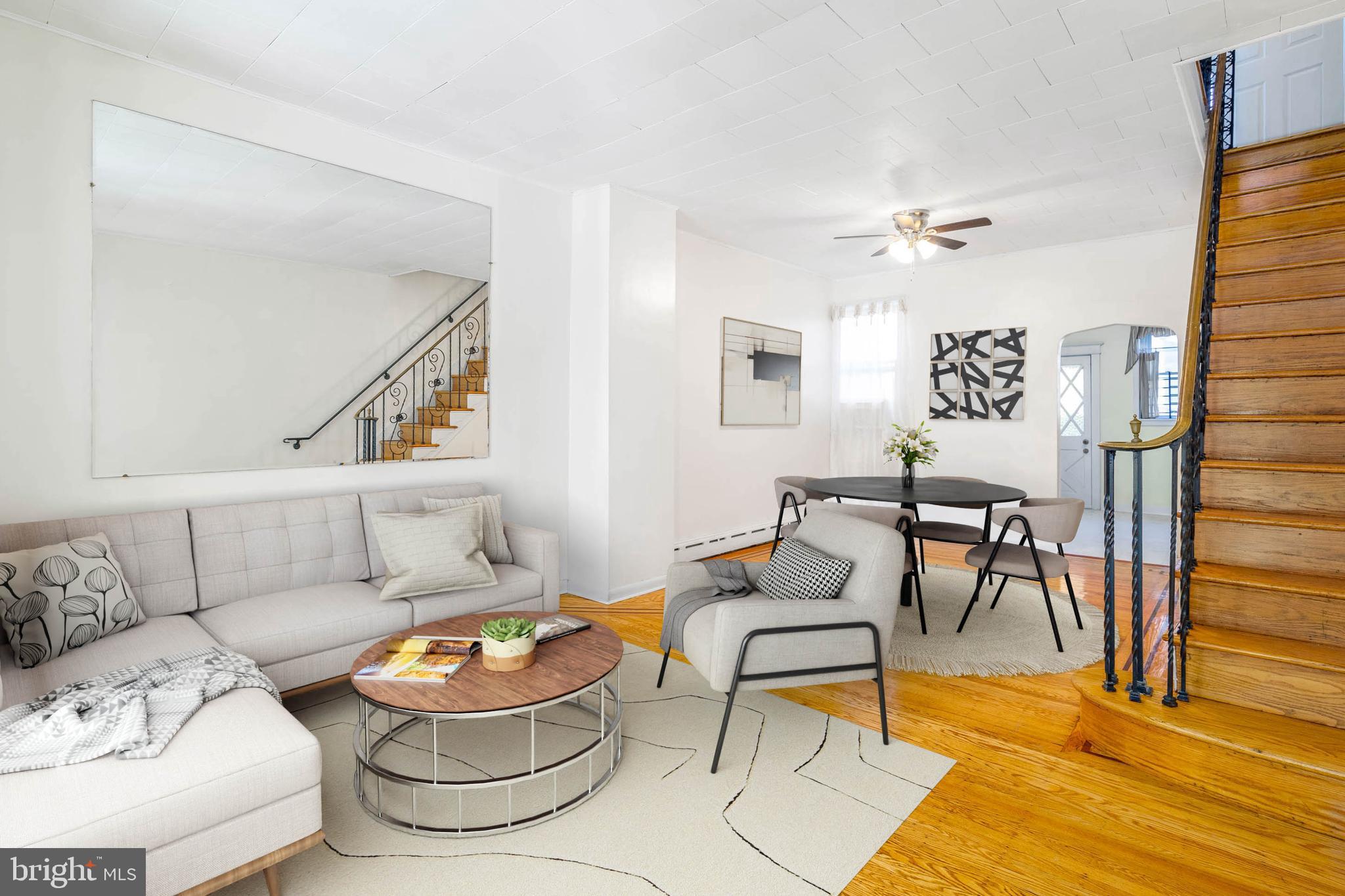 Welcome to this beautifully remodeled 3-bedroom, 1-bathroom row home in the heart of Point Breeze, South Philadelphia. This home combines classic charm with modern updates, featuring an open floor plan with refinished original hardwood floors, fresh paint, and abundant natural light. The first floor includes an enclosed front porch, a spacious living and dining area, and a modernized kitchen with oak cabinetry, quartz countertops, a stylish tile backsplash, and top-of-the-line appliances. Upstairs, three generously sized bedrooms with ceiling fans and a newly updated bathroom offer comfort and style. The finished basement provides additional living space, perfect for a home office or playroom, along with a laundry area. Recent upgrades include a new rubber roof, energy-efficient windows, an upgraded 200-amp electric panel, and modernized electrical systems, ensuring long-term peace of mind. Outside, enjoy a professionally redone stucco rear façade and a backyard patio perfect for entertaining. Conveniently located near public transportation, shops, and restaurants, this move-in-ready home is a must-see for first-time buyers or investors. Schedule your showing today! Some photos are virtually staged.