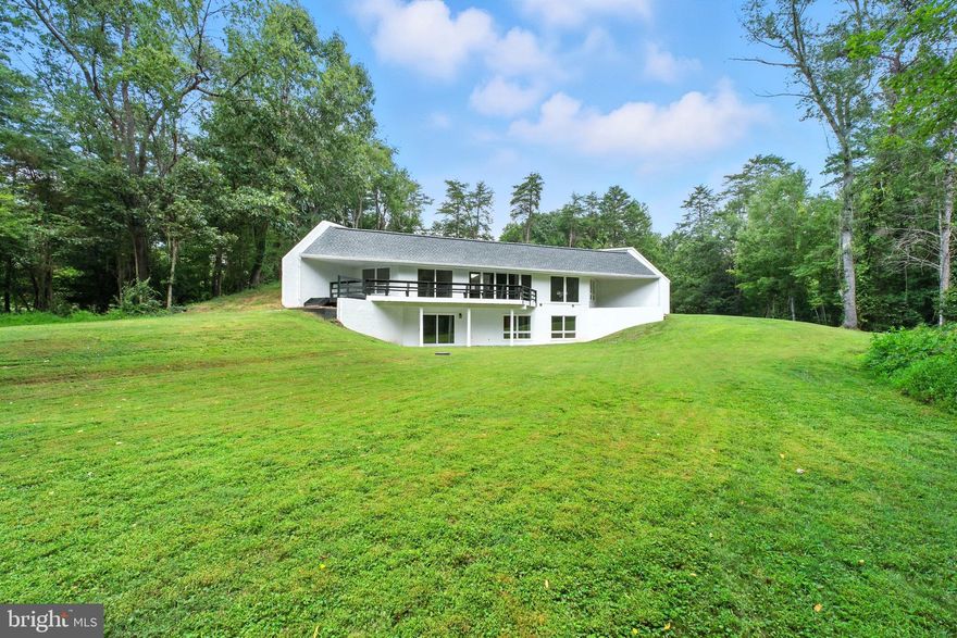 Fully renovated contemporary home on a private 2-acre lot, secluded yet accessible on a road that ends in a cul-de-sac, with no HOA. Just 10 minutes from Tysons Corner via Old Dominion or Route 7, the property offers the perfect balance of privacy and convenience, with endless possibilities. Inside, modern design meets premium upgrades: a gourmet kitchen with custom-made cabinets, brand-new vinyl flooring and carpets, and fully renovated bathrooms with modern fixtures. Recent improvements also include a brand-new TPO roof, fiber board siding, new A/C system, smart home appliances, and updated plumbing and electrical brought up to current code. Move-in ready with room to create the lifestyle you desire.