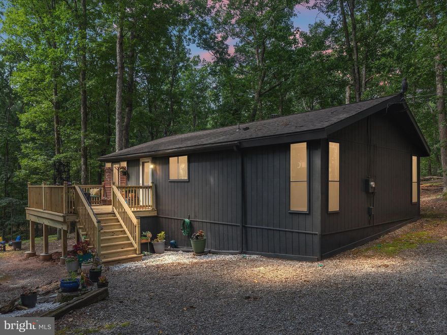 Welcome to your vibrant, charming retreat in The Woods Resort. Tucked away on a private, tree-lined lot, this lovely 2-bedroom, 1-bath home offers one-level living in a serene setting. The remodeled kitchen features granite countertops and updated appliances.

A brand new fireplace insert and chimney add comfort and character to the cozy living area. Step outside to enjoy the brand new deck or unwind in the screened porch, both perfect for relaxing in the natural surroundings. The freshly painted exterior gives the home a clean, updated look, and the setting back from the road offers added privacy.

Additional highlights include a dedicated laundry room with storage located just off the bedroom. Whether you're looking for a full-time residence or a weekend getaway, this move-in ready home is full of charm and comfort.