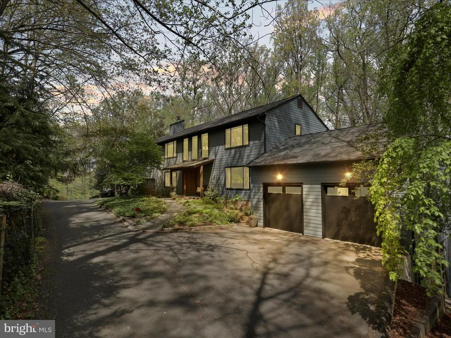 Unique, Upgraded and Full of Character---No cookie cutter here!  Ideally perched with a full length deck spanning  the back of the house to soak in the spectacular views.   The serene, wooded yard is adjacent to County Park Land offering privacy and a peaceful, natural setting.   Beautifully updated, sunny & bright kitchen with island, peninsula, pantry, abundant cabinetry and stunning granite countertops.   Spacious  Family Room off kitchen boasts a striking stone surround FP---perfect for cozy evenings.   Main level office has a wall of windows which creates an inspiring workplace.   This home includes Two- Oversized 2 car garages, one on each side of home---ideal for car enthusiasts or extra storage!   Upstairs you will find  4 generous BR's, convenient laundry room and comfortable sitting area/library at the top of the stairs.  Delightful Primary Suite  includes a sitting area, romantic Juliet Balcony, His &  Her  Walk in Closets and beautifully upgraded en-suite  bath.  The walk out Lower level includes the 5th Bedroom, full bath, spacious Rec & Exercise Room, Utility Room plus tons of storage.   Outside the flagstone patio sets the stage for barbecues, gatherings or just relaxing.  Beautiful exterior is all Hardi-Plank.   One incredible home!!