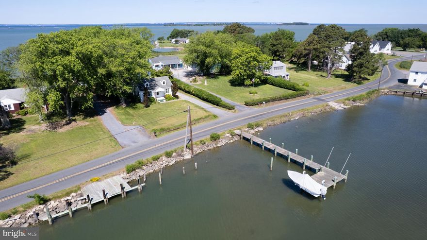 **PRICE IMPROVEMENT JUST IN TIME FOR SUMMER**The views just don't get any better! This cozy island bungalow owns waterfront on both the Chesapeake Bay & protected water's of Back Creek. 2 bedroom home is a great place to make your weekend getaway or full time spot. Home features lovely wood floors, spacious kitchen, laundry/mud room and more! Enjoy harbor views of PL Jones Boatyard & Back Creek from the front of the home. From the rear you'll be overlooking Tar Bay & the Chesapeake Bay- watch the boats and ships sail by! Property features a raised shed with a wood floor (as-is condition) and a "Bay House" a great space with a ton of potential! The "Bay House" is a 2-story structure on the bank of the bay with electric- a great studio for art/yoga, office retreat, happy-hour/bar destination, or simply a spot for the family to hangout and enjoy; it does offer heat panels in the ceiling for colder days. Private dock-site offers 3' MLW, electric lift, and did we mention the boat conveys with an acceptable offer?! That's right the house will convey fully furnished and you'll also get a Maycraft 1800 center console skiff with Yamaha 75HP 4-stroke motor- You can start enjoying the property immediately! Enjoy all that "Chesapeake Country" has to offer- fish, crab, boat and enjoy right from your doorstep! Hoopers Island is a working fishing village, island amenities include: Old Salty's Restaurant, post office, and at the Hoopers Island General Store you can get a bite to eat, provisions, and gas...dont miss out on their yummy desserts! House is listed below appraised value! Waterfrontage reflected is for both bodies  of water (96.15 on bayside, 76.47 on creek side per deed)