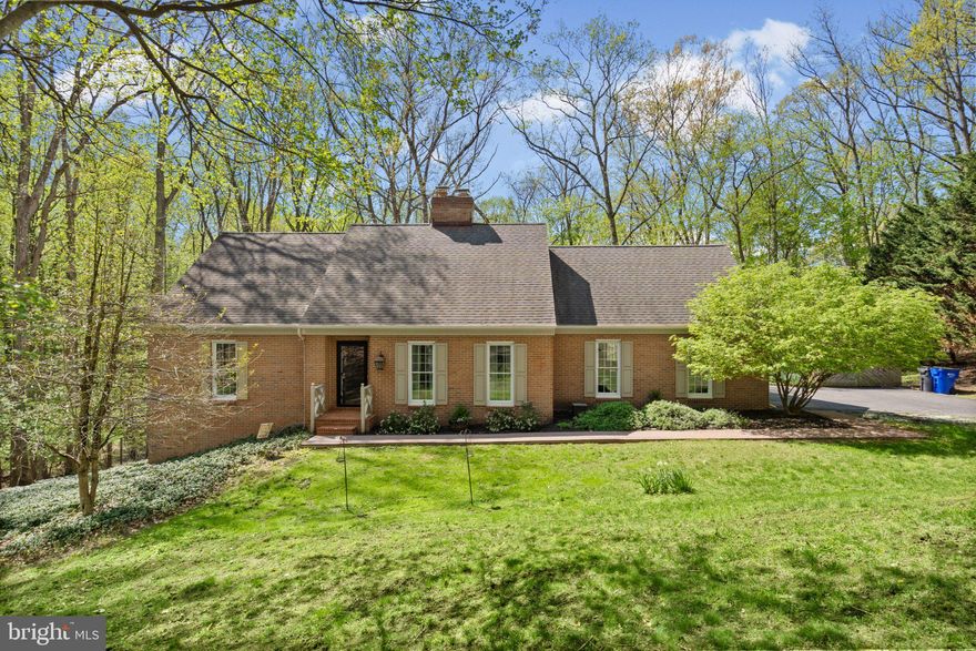 Welcome to this stunning all brick colonial gracefully set on a private, wooded lot, offering a rare blend of elegance, comfort, and peaceful surroundings. From the moment you arrive, the home impresses with timeless curb appeal and an oversized two car attached side load garage. Inside, gleaming hardwood floors flow throughout the main level, beginning in the inviting foyer and continuing into the light filled family room, beautifully appointed with crown molding and a striking two sided fireplace that seamlessly connects to the kitchen.

The heart of the home is the updated gourmet eat in kitchen, thoughtfully designed with granite countertops, beams, crown molding, recessed lighting, a walk in pantry, and updated appliances. The shared fireplace adds warmth and character, while serene wooded views create a truly special everyday setting. The kitchen also provides direct access to the garage for added convenience and opens to a composite rear deck, perfect for relaxing or entertaining while enjoying the peaceful natural backdrop.

The main level primary suite serves as a private retreat, featuring crown molding and direct access to the rear deck, allowing you to take in the tranquil surroundings morning and night. The main level also includes a full laundry room and a beautifully updated full bathroom complete with a jetted soaking tub, separate shower, and dual vanity.

Upstairs, you will find two generously sized bedrooms with plush carpet. One bedroom features a walk in closet and private ensuite bath, while the second offers a unique secondary staircase with direct access to the garage. The upper level also showcases a sprawling loft with a skylight, ideal for a home office, fitness area, or versatile flex space.

The unfinished lower level provides endless possibilities for customization and includes walkout access to a covered lower deck, further enhancing your outdoor living space.

With its serene setting, impressive interior, thoughtful updates, and convenient access to everyday amenities, this home offers a lifestyle that is both refined and relaxed. The home boasts several key improvements, including an updated roof, HVAC, and hot water heater. Inside, the refreshed kitchen and various other updates throughout make this property truly move-in ready. Shed, deck, chimney, and awning convey as is.