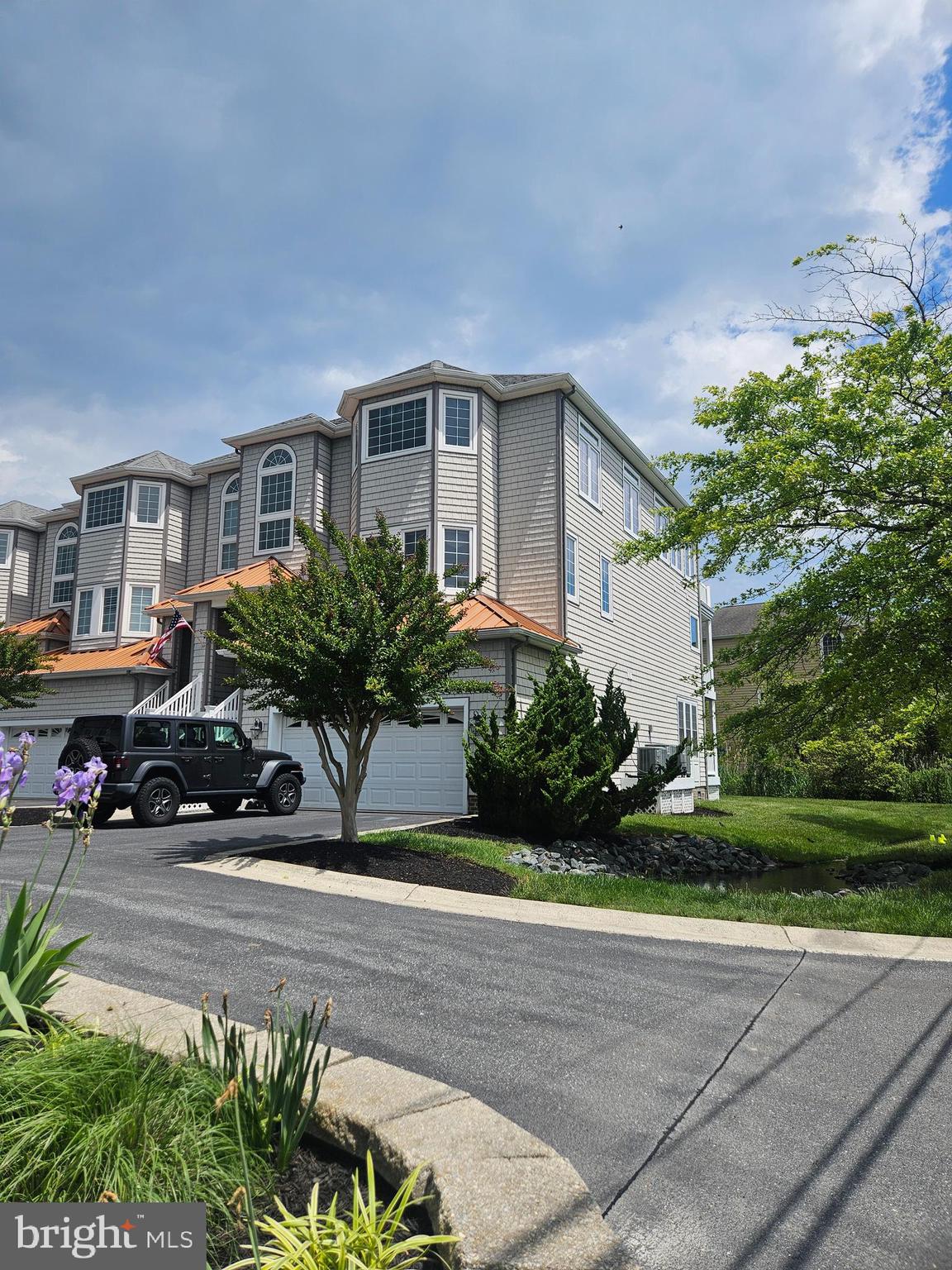 Come enjoy this luxury end unit Bay/Oceanview townhome with sweeping views of the Ocean City skyline, Martha's Landing & Sunset Marina. The first floor has a lockout apartment with a full kitchen, living room, private entrance and a washer/dryer hookup. The second floor has the primary bedroom with a luxury bath and a den/office with a private deck. There are also two additional bedrooms and a full bath. The third floor has a family room with a wet bar and gas fireplace, a dining room and eat-in kitchen. There is an open balcony with great views of Marinas and Ocean City on the third floor as well..
With additional amenities including an elevator, custom paint & window treatments, Corian counters, built-in ceiling speakers wired for Bose sound, a built-in safe and tinted windows, this home is sure to please!