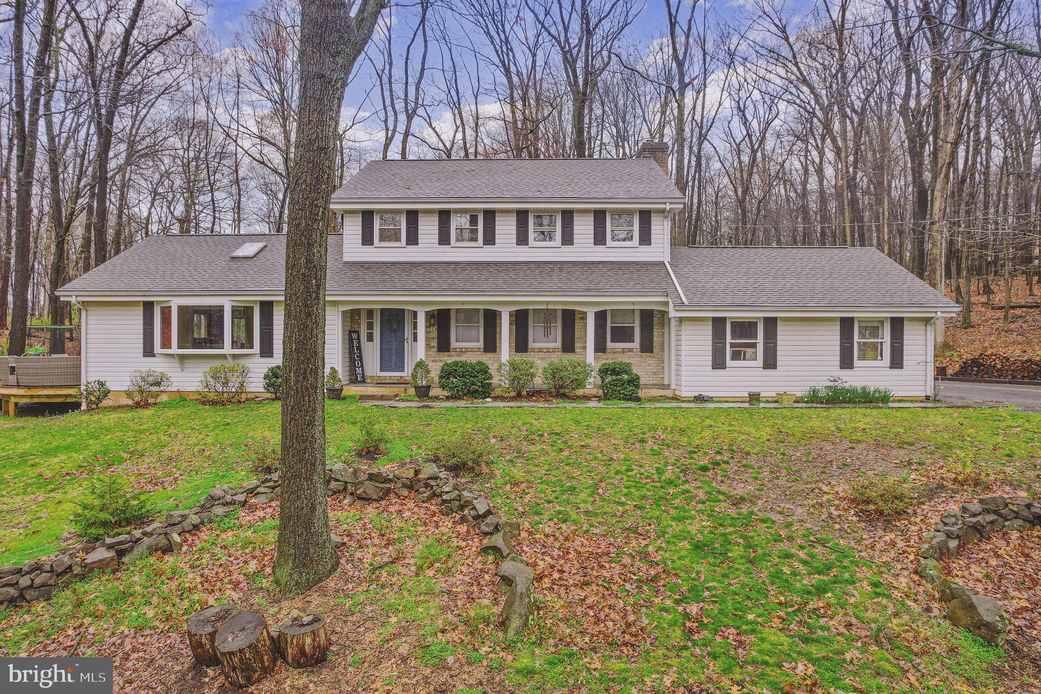 Welcome to the Sweetest Place on Earth! This custom two-story home nestled on a picturesque wooded 1.22-acre double lot in sought after Hillcrest Community, Derry Township. The moment you arrive you will immediately fall in love with how you’re surrounded by nature and still just being minutes from in-town Hershey and Penn State Medical Center. Updated and cared for, this charming home filled with warmth & character offers a perfect blend of modern and contemporary design. Walking up to the home you are greeted by the shaded covered front porch overlooking complete tranquility. The formal entry features a ceramic tile floor and a full guest bathroom with shower. The light infused living room has hardwood floors, sky light, a large picture window and a sliding glass door leading to the trex wooden deck, hot tub, and endless views. The light and bright eat-in kitchen offers white cabinets with a pantry cabinet, corian countertops with breakfast bar, L-shaped desk, full stainless steel appliance package to remain, two skylights, and a dining area with a custom built-in server. The family room/ possible separate living quarters is a wonderful place to gather. Enjoy the warmth and comfort of the stone fireplace with a wood stove insert, large picture window, and an exterior door leading to the attached two-car garage and concrete patio. Off the family room you will enjoy having a first-floor bedroom with walk-in closet and full bathroom with a low-profile walk-in shower. Main floor also offers a mud/laundry room with an upgraded washer/dryer to remain and a powder room. Second Floor features a master bedroom with a walk-in closet with a custom organizer system. Master bathroom offers a decorative single basin vanity with make-up area, ceramic tile backsplash and shower stall with glass enclosure and ceramic tile surround. The second floor offers three additional generous size bedrooms all with easy access to the main bathroom with a tub/shower combo. Need to get away? Rest assure you can, the partially finished basement with exterior access offers a spacious recreation room. The recreation room offers recess lighting, custom built-ins and access to a large storage room, and a bonus room with cedar lined closets. With a great indoor/outdoor flow and breathtaking lot truly makes the Sweetest Place to call Home. Please call today for your private showing. More Surprises Await!