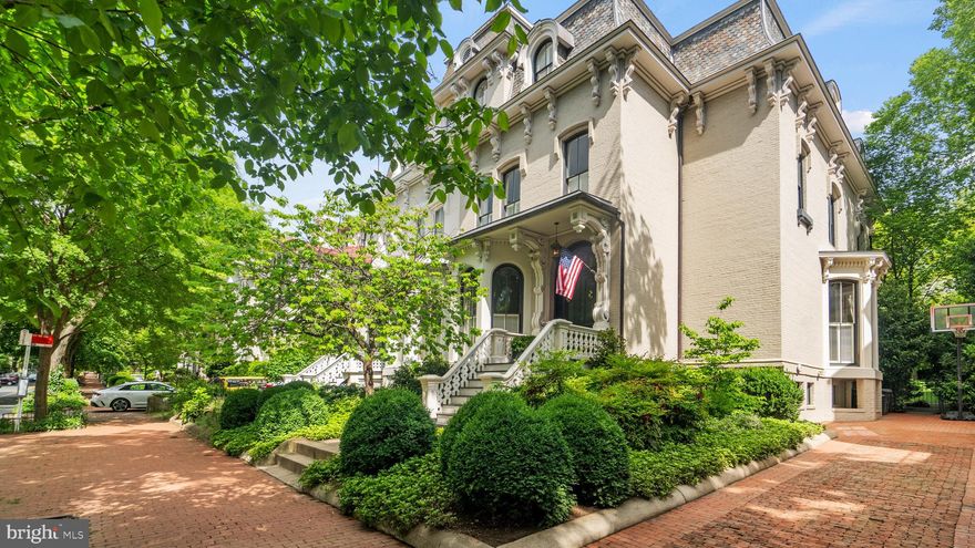 Originally built in 1868, this magnificent residence situated on historic Cooke's Row in Georgetown offers a blend of old-world charm and modern elegance. As part of Henry J. Cooke's visionary project for his family, this home has a rich history, once serving as the residence of the first Governor of the District of Columbia. 

Over the years, it has retained its grandeur, while enjoying restorative updates throughout. A stately front exterior with original civil-war era details greets you as you make your way inside to the main level featuring beautiful hardwood floors, soaring 14-foot ceilings, and gracious living spaces. Three fireplaces with original mantels provide warmth and character to the large living room, dining room, and library with custom floor-to-ceiling bookcases. Bay windows provide an abundance of natural light. The updated eat-in kitchen with marble counters provides direct access to the rear deck, which overlooks the home's beautifully landscaped rear yard, made private by mature trees and an expanse of lawn. 

Up the three-story, free-floating spiral staircase, the second level includes a cozy family room, a large office, and two generously sized bedrooms with their own en-suite bath. On the top floor, along with a private guest suite and laundry room, the primary suite features a spacious and sunny dressing room and an en-suite bath with large soaking tub, dual vanities, and a double shower. The lower level offers additional living space with a fifth bedroom, full bathroom, wine cellar, large storage room with a second laundry area and a separate craftsman's work room. Complete with driveway parking, this home offers exceptional living in the heart of Georgetown.