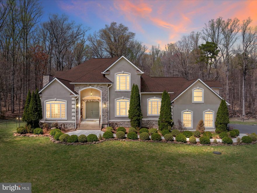 Welcome to this exquisite 6942sqft  luxury estate, nestled on over 5 acres of beautifully landscaped grounds. This stunning home offers an unparalleled blend of elegance, comfort, and modern amenities. Featuring 4 spacious bedrooms, each with its own bathroom, and an additional full bathroom on the main level, this home is designed for both luxury and convenience.
As you enter through the grand foyer, you'll be greeted by gorgeous hardwood floors and custom woodwork that set the tone for the rest of the home. The formal dining and living rooms are adorned with elegant columns and chair molding, creating a warm and inviting atmosphere. Throughout the home, you'll find 4 propane fireplaces with beautiful custom surrounds and mantelpieces, adding charm and warmth to various rooms.
The gourmet kitchen is a chef's dream, boasting custom wood cabinetry, some with glass doors, Corian countertops, stainless steel appliances including a double oven, and bar seating. Adjacent to the kitchen is a cozy dining area, perfect for casual meals. Above the garage, you'll find a spacious one of 2 primary  bedroom suite with beautiful windows, a cozy large  junior suite with fireplace, and a full bathroom, offering a versatile space for guests or additional family members.
The upper level includes the luxurious primary suite, which features a sitting room with a double-sided propane fireplace, a custom tray ceiling, a walk-in closet, and a primary bathroom with double sinks, a soaking jetted tub, and a walk-in shower. Two additional bedrooms, each with its own full bathroom, complete the upper level. The home also includes dual staircases, an open floor plan, and a large laundry room with cabinetry and a utility sink.
The exterior of the property is equally impressive, with a three-car garage, a paved stone fire pit, a custom rock water feature, a garden shed, outdoor light poles, and a walking path through the woods. The circular gravel driveway and long paved driveway provide ample parking, accommodating at least 11 cars on the paved driveway and three cars on the gravel driveway. The beautifully landscaped grounds feature flowering trees and shrubs, adding to the property's charm.
This home is equipped with a top-of-the-line propane Carrier dual zoned heating system, a water treatment system with UV light, a well, and a recently pumped septic system. An automatic turn-on Generac generator and a radon system ensure safety and convenience. All systems have been well maintained and cared for, providing peace of mind for the new owner.  
Notable Updates Include: Generator serviced in July 2024; Fireplaces inspected and serviced in July 2024; Hot water heater replaced in Aug 2023; Water treatment system service in July 2023; New 5-Ton furnace in May 2023; Newly paved driveway in 2022; New shed with pad in 2022; Additional circular gravel driveway in 2020.
Schedule your showing today! Appointment only - No drive ups please . Total  6953 sq. ft = BELOW GROUND: 2347 sq. ft, FLOOR 2: 2304 sq. ft, FLOOR 3: 664 sq. ft, FLOOR 4: 1628 sq. ft - EXCLUDED AREAS: PATIO: 500 sq. ft, GARAGE: 745 sq. ft, STORAGE: 34 sq. ft, ELECTRICAL ROOM: 13 sq. ft, FIREPLACE: 24 sq. ft, OPEN TO BELOW: 655 sq. ft