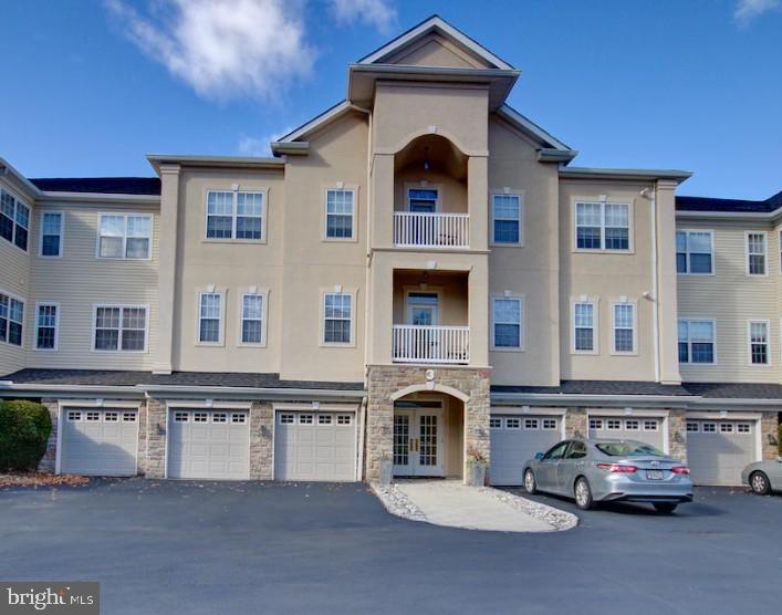This is your opportunity to access the highly desirable Holland Preserve 55+ community. Very rarely offered. Ground floor unit with easy access to garage - no elevator necessary. Backs up to an open green area with beautiful views. Upon entering, you'll be greeted with an updated and nicely appointed kitchen to your right with custom cabinetry and stainless appliances. Open views to the large living room with full sliding door view of the back patio and open area. The large primary bedroom has two ceiling fans, multiple closets, and an updated bathroom with a large shower and double vanity. Additional linen closet in the bathroom. The other side of the home offers a dining room right off the kitchen and entryway, a full guest bath, large guest bedroom with a huge walk-in-closet. Also on this side of the home is a washer and dryer for convenient use. Take in the beautiful surroundings while enjoying a book or coffee on your back patio. One car, oversized, garage provides convenient inside access to your home! This home surely won't last!.