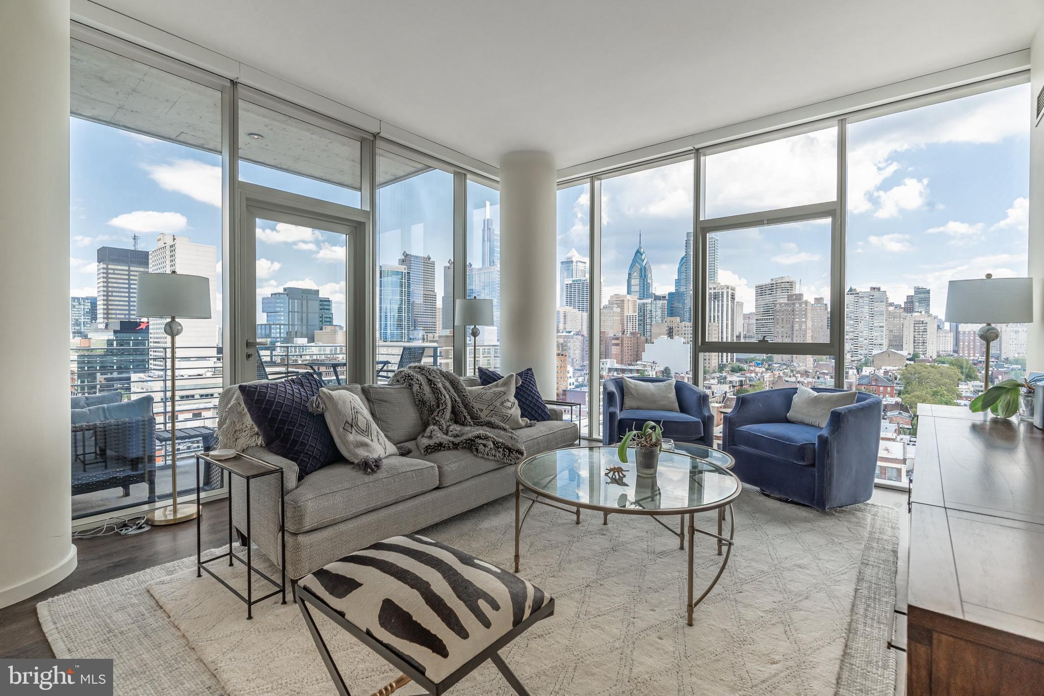 Welcome to ONE RIVERSIDE, Philadelphia’s ultimate luxury condo building in the heart of Fitler Square. Unit 1403 spans 1227 sq ft and features 2bd, 2.5 baths, one parking spot, and is the highest floor the coveted 03 floorplan is offered. Enjoy unobstructed panoramic views of the city, including the north river corridor, FMC Tower, the Art Museum, and the river trail. The unit also has around 5 years remaining on the tax abatement.
Walking through the doors to this sleek luxury condo, you enter through the foyer and into a bright and airy kitchen and living room area, with high ceilings, newly finished wood floors, and show-stopping views of the river and surrounding city life through the floor to ceiling windows. The gourmet kitchen is any chef’s dream, with Miele appliances, custom white cabinetry, and marble countertops for your guests to hang while you're entertaining. There is also room for an additional seating area next to the island, where you can enjoy coffee and breakfast with an incredible view, or head outside to your private balcony for some fresh air. Adjacent to the kitchen is the sun-filled living area, perfect for entertaining and everyday relaxation.
There is a powder room situated between the kitchen and living room with lovely accents. Next to the living room, you will find your first bedroom, complete with an ensuite bath. This bedroom offers impeccable views and is very spacious. The ensuite offers a stand-up shower and marble accents throughout and is perfect for guests or home office.
Back towards the entrance hall, you’ll find your primary bedroom with floor to ceiling windows and spa-like ensuite bathroom. Your bedroom is also outfitted with two large closets. Wake up every the morning to a flood of natural sunlight with a view of the river, and enjoy your en-suite bath, with oversized soaking tub, frameless glass shower, and double marble vanity with custom cabinetry and storage.
This residence also includes a laundry closet with a full-sized washer and dryer.
Built by premier developer Carl Dranoff and designed by acclaimed architect Cecil Baker, One Riverside is located in charming historic Fitler Square. One Riverside is within easy walking distance of Rittenhouse Square, the University of Pennsylvania, Drexel University, 30th Street Station, CHOP and the just named BEST URBAN TRAIL IN THE NATION. One Riverside also offers full service concierge and door staff, chauffeur driven town car, state-of-the-art fitness center with locker rooms, saunas, steam rooms and showers, 60' indoor lap pool, club room with a catering kitchen, board room, hospitality suite, bicycle storage, private pocket park, and an outdoor terrace equipped with BBQ grill and television. Parking license for one car included in list price. Don’t wait to take advantage of the ultimate living experience near the river, the park, the trail, and the city.