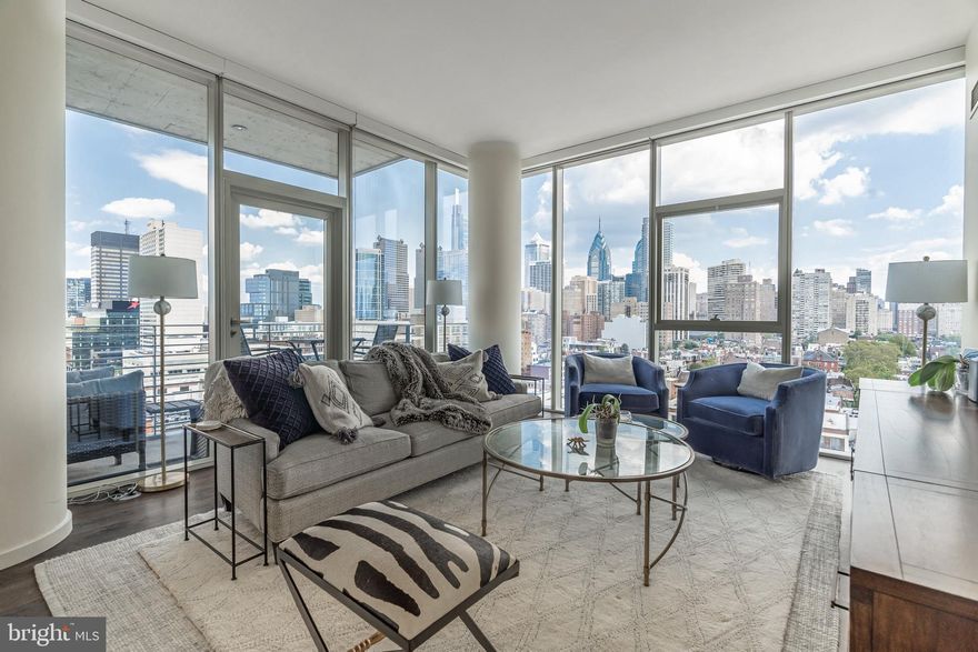 Welcome to ONE RIVERSIDE, Philadelphia’s ultimate luxury condo building in the heart of Fitler Square.   Unit 1403 spans 1227 sq ft and features 2bd, 2.5 baths, one parking spot, and is the highest floor the coveted 03 floorplan is offered.  Enjoy unobstructed panoramic views of the city, including the north river corridor, FMC Tower, the Art Museum, and the river trail. The unit also has around 5 years remaining on the tax abatement.

Walking through the doors to this sleek luxury condo, you enter through the foyer and into a bright and airy kitchen and living room area, with high ceilings, newly finished wood floors, and show-stopping views of the river and surrounding city life through the floor to ceiling windows. The gourmet kitchen is any chef’s dream, with Miele appliances, custom white cabinetry, and marble countertops for your guests to hang while you're entertaining.  There is also room for an additional seating area next to the island, where you can enjoy coffee and breakfast with an incredible view, or head outside to your private balcony for some fresh air.  Adjacent to the kitchen is the sun-filled living area, perfect for entertaining and everyday relaxation.

There is a powder room situated between the kitchen and living room with lovely accents. Next to the living room, you will find your first bedroom, complete with an ensuite bath. This bedroom offers impeccable views and is very spacious. The ensuite offers a stand-up shower and marble accents throughout and is perfect for guests or home office.

Back towards the entrance hall, you’ll find your primary bedroom with floor to ceiling windows and spa-like ensuite bathroom. Your bedroom is also outfitted with two large closets. Wake up every the morning to a flood of natural sunlight with a view of the river, and enjoy your en-suite bath, with oversized soaking tub, frameless glass shower, and double marble vanity with custom cabinetry and storage.

This residence also includes a laundry closet with a full-sized washer and dryer. 

Built by premier developer Carl Dranoff and designed by acclaimed architect Cecil Baker, One Riverside is located in charming historic Fitler Square. One Riverside is within easy walking distance of Rittenhouse Square, the University of Pennsylvania, Drexel University, 30th Street Station, CHOP and the just named BEST URBAN TRAIL IN THE NATION. One Riverside also offers full service concierge and door staff, chauffeur driven town car, state-of-the-art fitness center with locker rooms, saunas, steam rooms and showers, 60' indoor lap pool, club room with a catering kitchen, board room, hospitality suite, bicycle storage, private pocket park, and an outdoor terrace equipped with BBQ grill and television. Parking license for one car included in list price. Don’t wait to take advantage of the ultimate living experience near the river, the park, the trail, and the city.