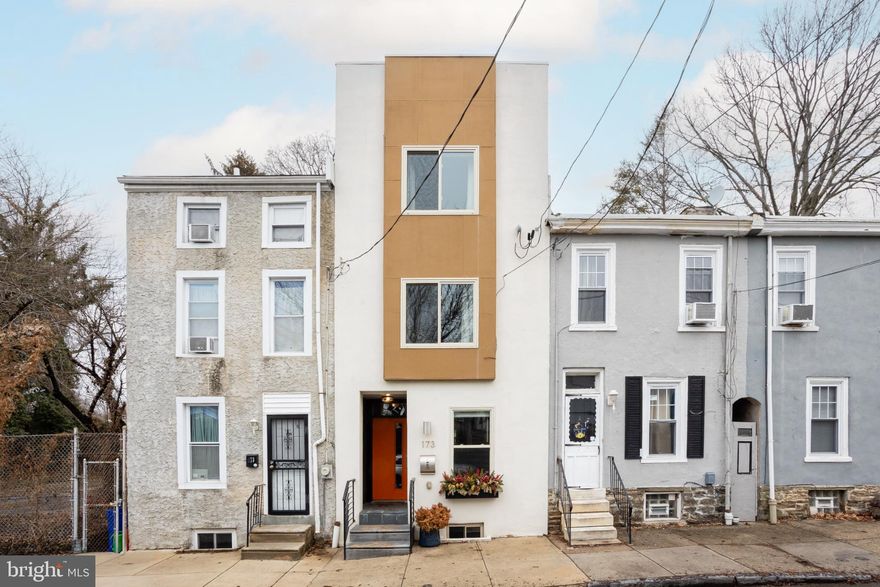 Discover the ideal blend of modern design, thoughtful details, and convenient neighborhood living in this 3‑bedroom + office/den, 2-bath Germantown home just steps from Wissahickon Park and Forbidden Drive.

Inside, wide‑plank hardwood floors, recessed lighting, and windows in every room create bright, spacious living throughout. The open first floor features generous living and dining areas flowing into an eat-in kitchen with stainless Whirlpool French‑door refrigerator, 5-burner GE range/oven, GE dishwasher, and a 28‑bottle wine cooler. Granite countertops, a large waterfall island with eating bar, soft-close shaker cabinetry, and subway tile backsplash combine style and function. Built-in open shelves provide space for décor, cookbooks, or kitchen essentials. Step through the half-lite glass back door to a spacious, landscaped rear yard. The patio combines concrete and paver areas with built-in planters, leading up to a grassy lawn — perfect for outdoor dining, gardening, or entertaining.

Upstairs, the second floor offers two large bedrooms with ample closet space, a full tile hall bath with dual vanities and tub/shower, and a hall laundry closet with full-size GE washer and dryer. The third floor includes a generous office/den with glass sliders to a private balcony, and a serene primary suite with walk-in closet and an updated bath featuring a frameless glass shower, dual vanities, and dual-flush toilet.

The unfinished basement provides abundant storage and a separate mechanical room. Additional highlights include custom iron and wood railings, contemporary woodwork and trim, built-in kitchen shelving, and a full sprinkler system throughout.

Just one block from Ultimo Coffee and Vernon Park, three blocks from Weaver’s Way Co‑Op and the Chestnut Hill West Line, and minutes from Manayunk, Mount Airy, and Chestnut Hill. A short drive to Center City and the River Drives, this home offers strong community, excellent walkability, and easy access to public transit and major highways.