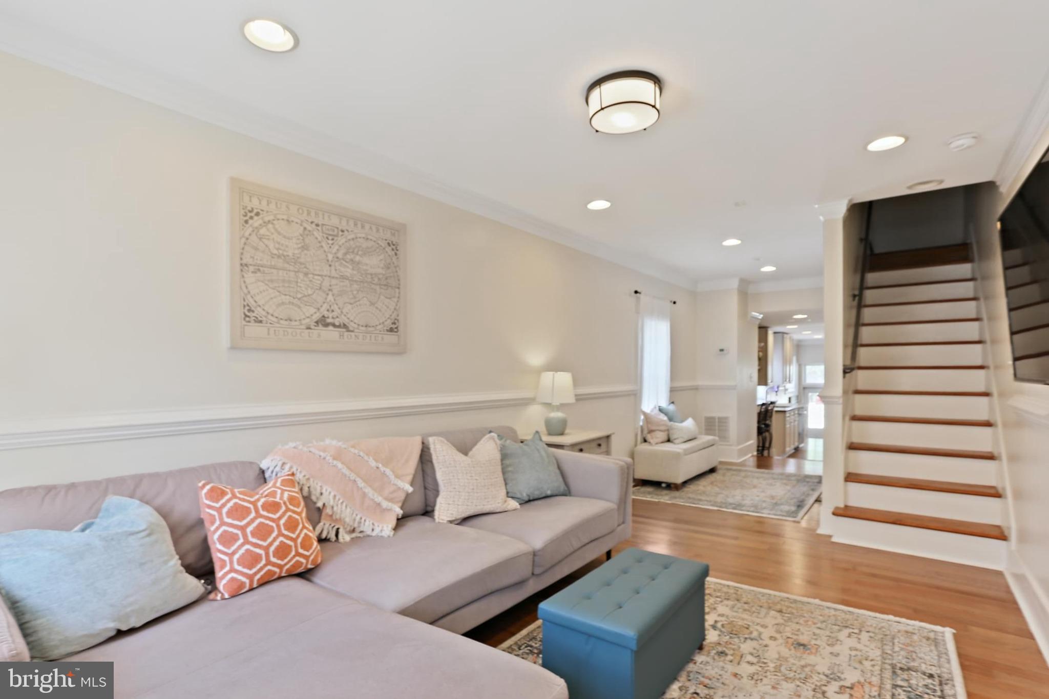 Welcome to this stunning three-story end-of-group rowhome in the heart of Locust Point—fully turnkey and rich with historic charm and modern updates. Featuring three above-grade bedrooms, this beautifully maintained home showcases gleaming hardwood floors and an abundance of natural light throughout the main and upper levels. The spacious family room flows effortlessly into the upgraded eat-in kitchen, complete with sparkling granite countertops, stainless steel appliances, and 42" custom cabinetry—ideal for everyday living and entertaining. Step outside to a private fenced patio, perfect for relaxing and unwinding. If desired, it could even be converted into a parking pad. Make your way upstairs and find a convenient laundry room, two generously sized bedrooms, a large closet space, and two full baths, giving you ample living space all around. The private top-level owner’s suite is a true retreat, offering two walk-in closets, a luxurious en-suite bath, and access to a rooftop deck. Entertain family and friends or have your morning cup of coffee from your private rooftop deck with sweeping views of the Baltimore skyline, Inner Harbor, and the iconic Domino Sugar sign. The semi-finished lower level provides excellent storage and a flexible space ideal for a home office, gym, or media room. All of this plus, location! Location! Location! Perfectly situated in Locust Point overlooking the Inner Harbor and well known for its rich history and charm with close access to Historic Fort McHenry, Latrobe Park, Underarmour Headquarters, and endless shopping and entertainment opportunities! The list goes on and on! Don’t miss!