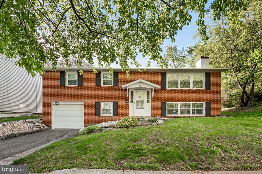 Welcome home! This beautifully maintained brick front bi-level offers timeless curb appeal, thoughtful upgrades, and a one-car garage - all tucked away on a tree-lined street in an established neighborhood. With a brand new roof, central air, and a host of recent improvements, this home is truly move-in ready. Step inside and upstairs to the inviting main level, where warm Pergo floors flow seamlessly through the spacious living room with a cozy wood-burning fireplace, into the dining area and kitchen. The kitchen features a double sink and dishwasher, and easy access to the lush backyard with concrete patio - perfect for gardening, entertaining, or relaxing - complete with a handy storage shed. The primary bedroom offers a generous double closet and an updated en-suite powder room, while two additional bedrooms - each with their own double closets - share a bright full hall bath featuring a tub surround, new toilet, and modern vanity. The lower level offers flexible living space, ideal for a family room, home office, or guest retreat. You'll also find a laundry area with new utility sink, storage/mechanical room, and convenient access to the garage. This home has seen significant upgrades in the last two years alone, including a new 200-amp electrical panel, new roof, new heat pump (backup oil burner), new water heater, and ceiling fans throughout. Additional updates during ownership include new double-pane windows on the main level, and replacement of gutters, soffits, and fascia. With a great layout, solid construction, and a long list of improvements, this home blends comfort, functionality, and classic charm. Don’t miss your chance to make this wonderful home your own!