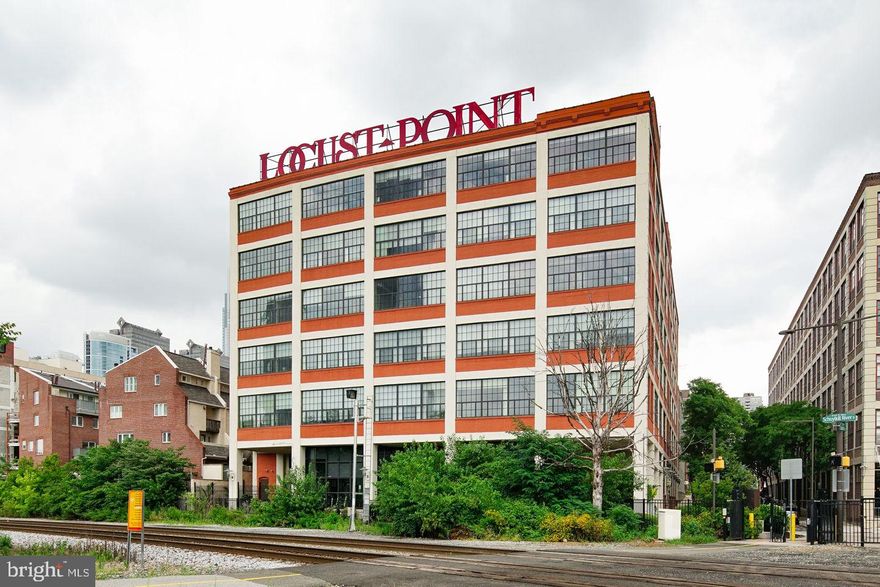 Welcome to Locust Point! This penthouse level corner unit offers picturesque views of the Schuylkill River and PARKING in the attached garage! This oversized layout includes one bedroom, one bathroom, a den/office area, an open concept living-dining area with soaring ceiling heights, TONS of closet/storage space, and gleaming wood floors throughout the main living area and carpet in the bedroom. The oversized wall of windows flood the apartment with an abundance of natural light, and the gourmet kitchen boasts rich wood cabinets, granite countertops, and stainless steel appliances. The massive wall of windows continues into the bedroom filling the room with natural light and the custom bedroom closet with built-in drawers and shelving complete the room while adding to the already abundant storage throughout the apartment. The bathroom features frameless glass doors, white subway tiles, a large mirror, and a granite top vanity. Enjoy the perks of living in this ideally located building with, garage parking, in-unit washer and dryer, 24-7 fitness center, on-site building management, maintenance, & resident lounge area with free wifi! This building is steps away from the Schuylkill River trail, the Filter Club, UPenn, Drexel, CHOP, Center City, Rittenhouse Square, top restaurants and shopping, public transportation, and major highways for easy access. Private in-person and virtual tours are available! This apartment is available furnished or unfurnished.