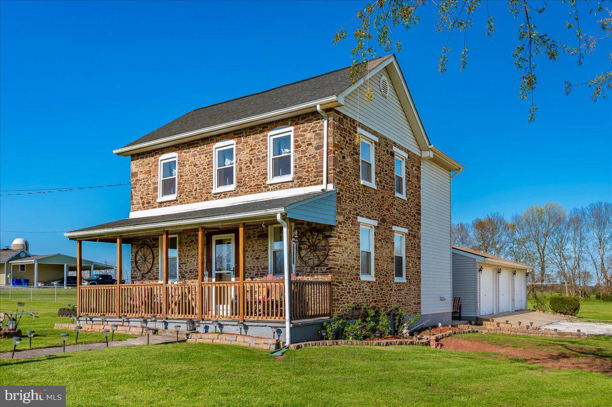 This inviting stone-front home, built in 1890, blends timeless character with everyday functionality. You'll love the deep window sills and the stone accent wall in the living room that adds warmth and charm. The main level features an eat-in kitchen, dining room, living room, full bath with laundry area. Upstairs offers two bedrooms and a second full bath. Need more space? Converted back to a 3-bedroom layout to suit your needs. Outside, enjoy an attached 3-car heated garage, multiple sheds, and a detached garage with electricity—ideal for gathering space, hobbyists, or more storage. All situated on 3 flat, open acres with endless potential for outdoor living, gardening, or entertaining. Don’t wait—see the possibilities and make this home yours!