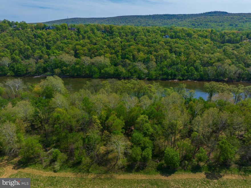 Once‑in‑a‑generation opportunity — 20+ acres with nearly 1,000 feet of pristine Shenandoah River frontage and sweeping mountain and river views. This rare offering includes five parcels with the potential to create up to four additional buildable lots, ideal for a family compound, private retreat, or development opportunity. The property is anchored by a stately brick rancher featuring a generous main level and a full in‑law suite on the lower level, offering flexible living arrangements and rental potential. Mature hardwoods, peaceful riverfront frontage, and long-range vistas create an exceptionally private, park‑like setting. Easy river access, abundant wildlife, and stunning sunset views complete this slice of paradise. Don’t miss your chance to own a truly remarkable piece of the Shenandoah.