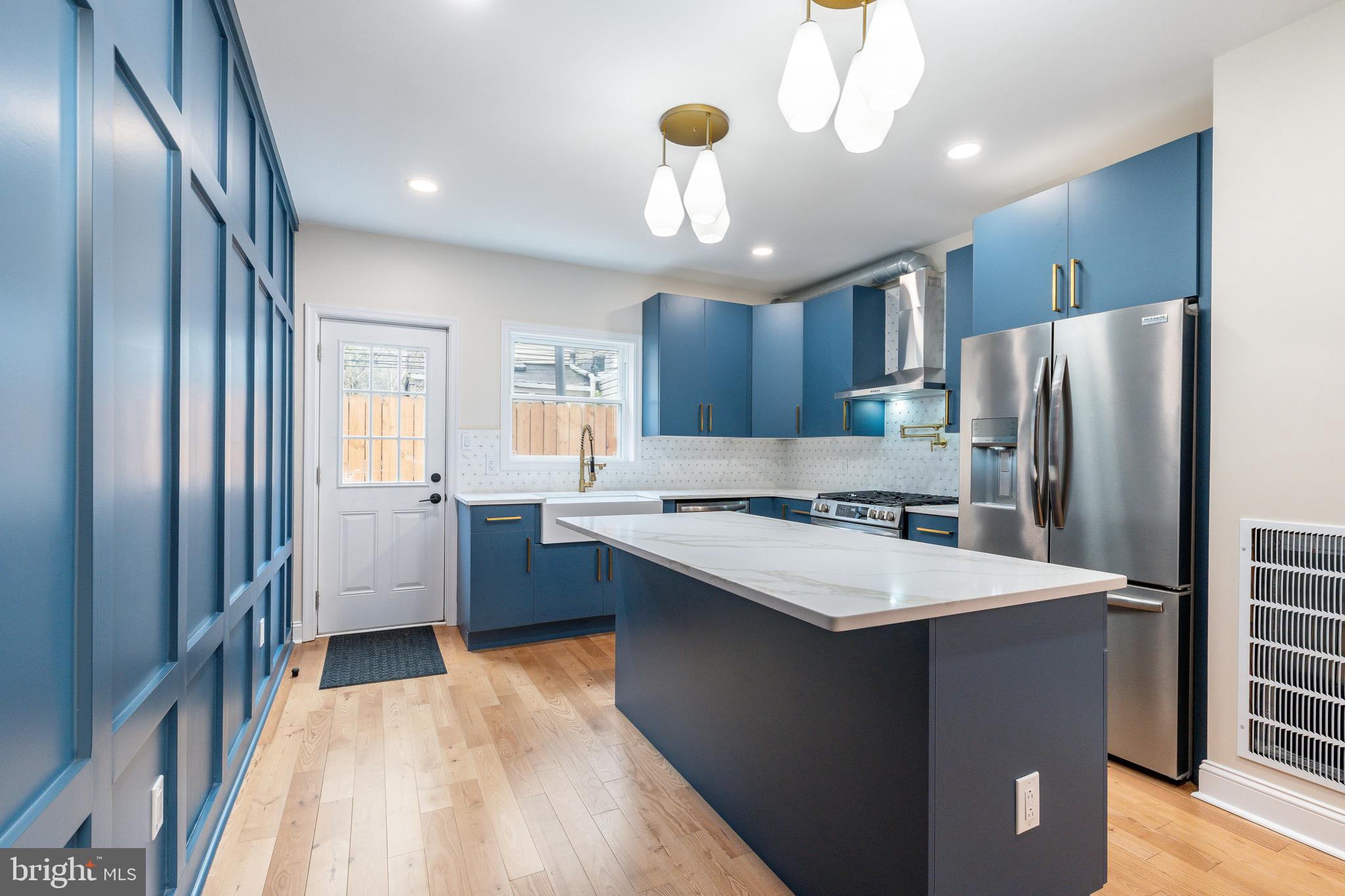 Discover urban living at its finest in this beautifully renovated 3-bedroom, 3-bathroom home, perfectly situated on a popular block near Washington Ave in Point Breeze. This beauty blends historic charm with modern design, featuring an original red brick façade, exposed brick accents on the first floor, hardwood floors throughout, and not one, but three outdoor spaces including a private roof deck with skyline views. The sleek, open kitchen is a total showstopper — custom deep blue cabinets, brushed gold hardware, quartz countertops, a farmhouse sink, stainless steel appliances, and a massive island perfect for entertaining. The bathrooms are equally impressive, especially the spa-like primary suite featuring a double vanity with gold fixtures, quartz counters, and a designer walk-in shower with elongated hex tile and built-in bench.
The layout is ideal: two bedrooms and laundry on the second floor, a full-floor primary suite on the third, and a fully finished basement with its own bathroom — perfect for a guest suite, office, or gym. You'll enjoy central air and heat, a walk-in closet in the primary suite, and tons of thoughtful details throughout.
This prime location puts you steps from vibrant dining and shopping along Washington Ave, with bus routes on both 22nd and 23rd Streets for easy commuting. Within 10 minutes, enjoy access to major highways, fitness centers, parks, and trendy cafes. Whether you're craving a night out or a peaceful stroll, this home offers the perfect blend of convenience and charm. Don’t miss this rare opportunity—schedule your showing today!