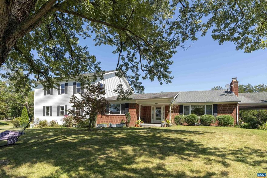 Expansive and comfortable home on 4.4 acres in a beautiful area of Nelson County, with stunning Blue Ridge views.  Solidly built brick ranch with a 2-story addition contains all the space you could possibly need.  3 bedrooms, offices, bonus rooms, dining room, spacious kitchen, and living room with wood-burning fireplace (brand-new stainless-steel liner).  Abundant storage in unfinished basement, plus 2 storage sheds (one has electric, insulation, and Air Conditioning) and a 10x20 equipment tent, whole house generator.  The front yard has a magnificent Maple tree, and views of The Priest and Three Ridges, Nelson Co.'s most prominent mountains.  4.4 acres includes pasture area, 40x80 fully fenced garden plot, 75 native trees and shrubs just planted, .2-acre native wildflower meadow, 10x12 secure chicken run, hundreds of flower bulbs, and a year-round stream on one boundary.  Professionally installed underground electric dog fence.  If you are looking for a small homestead, or just easy country living in a beautiful and peaceful setting, this is the spot.,Formica Counter,Oak Cabinets,Fireplace in Living Room