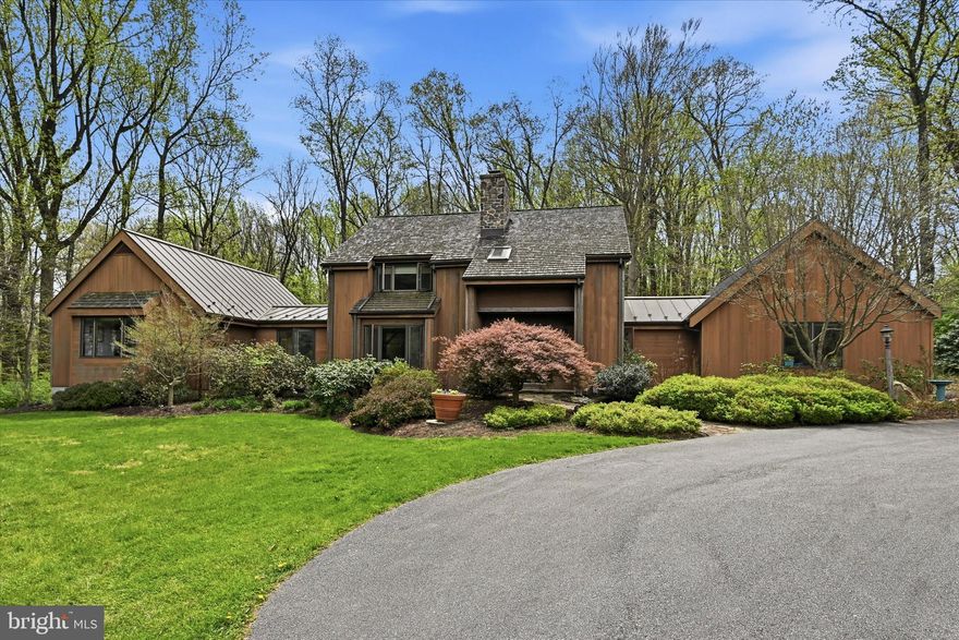 Nestled on approximately 6 private, picturesque acres in the heart of Kennett Square, this one-of-a-kind 3-bedroom, 2.5-bath Hugh Lofting timber frame home, designed by renowned architect Art Bernardon, offers a rare blend of architectural beauty, tranquility, and modern comfort.

From the moment you arrive, you’ll be captivated by the peaceful setting, surrounded by nature and enhanced by custom walking trails thoughtfully created by the current owner. Inside, the home showcases timeless craftsmanship with warm wood tones, soaring ceilings, and a stunning sunken living room anchored by a striking stone, wood-burning fireplace perfect for cozy evenings. Adding to the home’s character, the living room features custom walnut cabinetry crafted from trees harvested right from the property, creating a truly unique and meaningful design element.

The kitchen is both functional and inviting, featuring a blend of butcher block and granite countertops, ideal for everyday living and entertaining. Just beyond, a spacious rear deck provides the perfect place to relax and take in the breathtaking views and unmatched privacy.

The main level offers the convenience of a first-floor primary suite complete with an ensuite bath. Just before entering, a light-filled sitting room creates a peaceful transition into the space, offering beautiful views of the front yard and direct access to the rear deck, an ideal spot for morning coffee or quiet reflection. Additional bedrooms and a versatile loft area on the second floor provide flexible living space ideal for a home office, guest space, or potential fourth bedroom.

Additional highlights include a large dedicated office, a 3-car attached garage with a floored attic for ample storage, and an unfinished basement with direct access to the garage, offering endless potential for future expansion.

This extraordinary property is a true retreat where thoughtful design meets serene country living, all just minutes from the charm, dining, and culture of downtown Kennett Square.