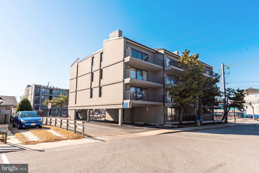 Enjoy easy first-floor living in this beautifully updated condo offering true convenience and an unbeatable mid-town location. Step outside to a large private balcony—perfect for morning coffee or unwinding after the beach. The unit includes two assigned parking spaces, one is covered and right outside your door, making access effortless. No more hauling luggage and groceries up the steps!

Inside, low-maintenance tile and luxury vinyl plank flooring flow throughout, complemented by an electric fireplace that adds warmth and ambience on chilly nights. The upgraded kitchen features stainless steel appliances, soft-close cabinetry, and granite countertops, while both bathrooms have been tastefully renovated.

Ideally located within a short walk to popular restaurants, shopping plazas and mini-golf—and just steps from a wide, pristine beach—this condo is perfect as a vacation home, or investment opportunity. Easy living, thoughtful upgrades, and an exceptional location all come together here.