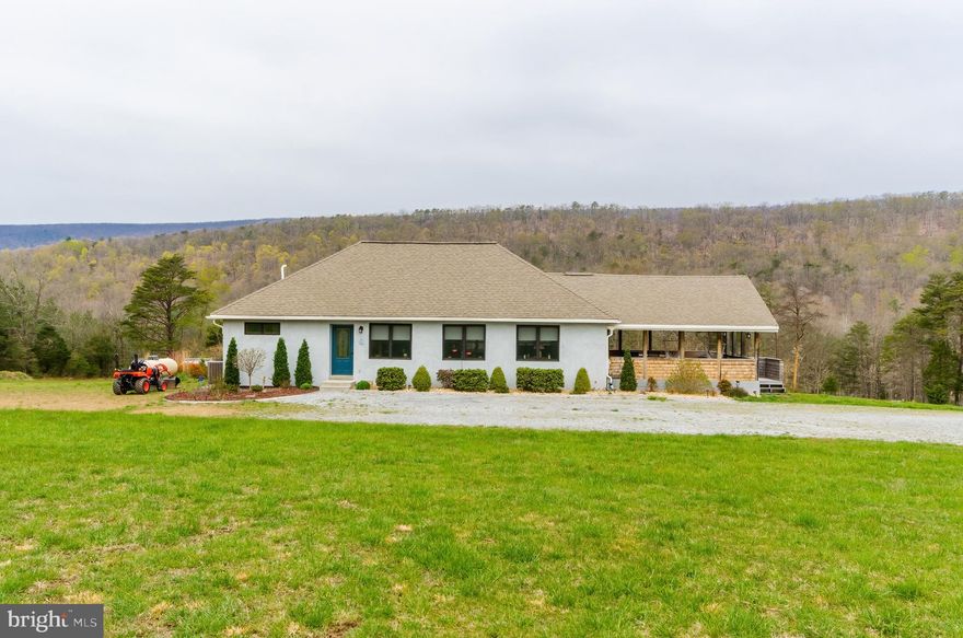 Welcome to 30 Clara Lane, a wonderful custom home situated on 8.76 unrestricted acres! Home boasts an open floor plan with cathedral ceilings, hardwood floors throughout the main level.  Spacious great room has lots of windows to let in natural light, wired-in speakers , the perfect room for entertaining or gathering.  The gourmet kitchen is loaded with upgrades, including 2 refrigerators, 2 wall ovens, gas cooktop,  baker's lift, gorgeous coriander countertops.  Each of the 3 bedrooms has its own private full bath.  Lower level is fully finished, with 2 bedrooms, large family room, and a kitchenette.  Perfect for an in-law suite,  or Air Bnb. Many possibilities here! Great location, convenient to 522 for commuters, just minutes from Cacapon State Park where you can enjoy outdoor activities.  Just a short drive to historic Berkeley Springs! Call today for your viewing, this one won't last long!