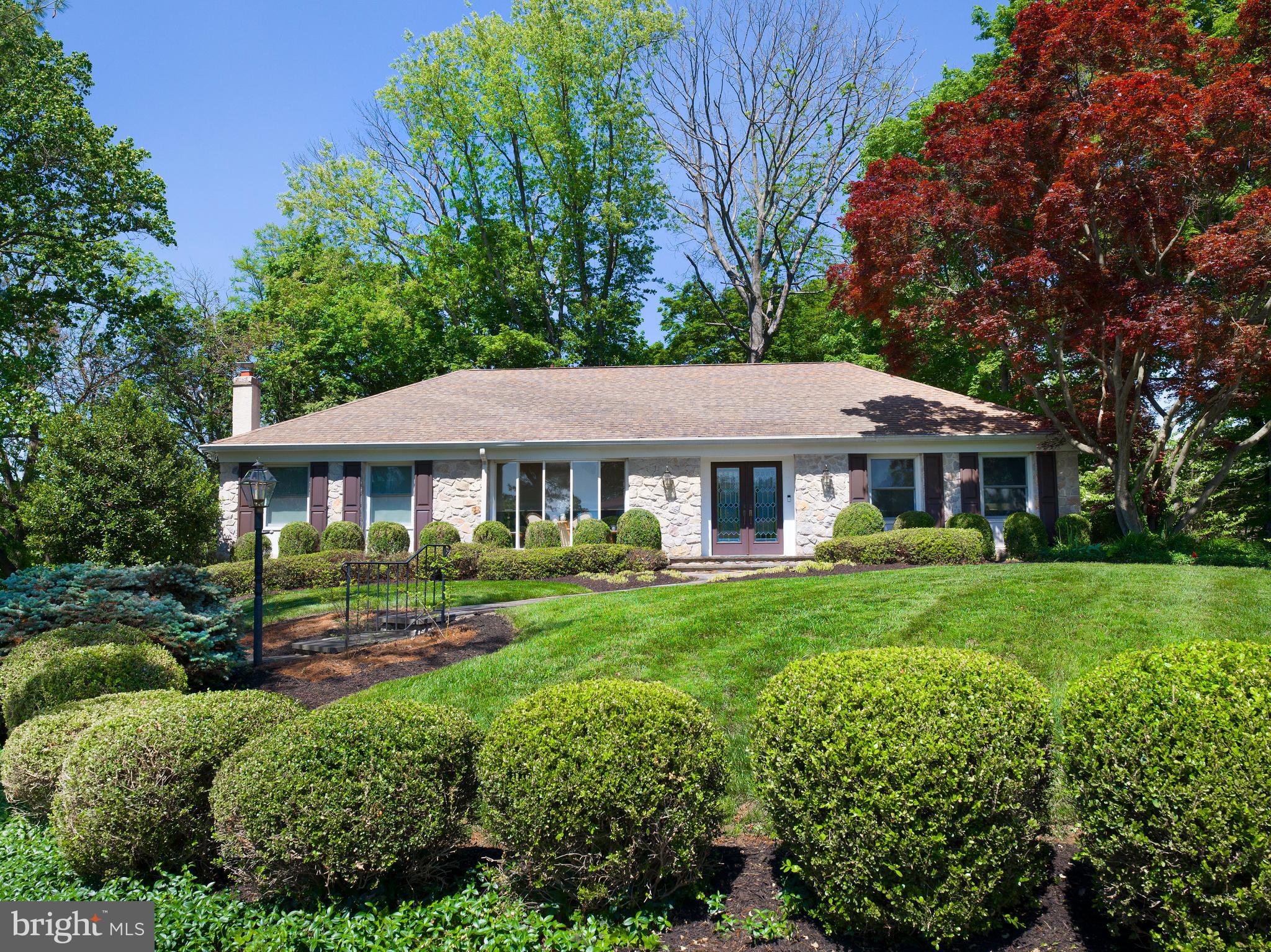 Welcome to 399 Ballytore Circle—where classic Main Line charm meets modern-day luxury in the heart of Wynnewood.
Tucked away on a quiet cul-de-sac and surrounded by lush, professionally manicured landscaping, this beautifully updated stone home offers the perfect blend of comfort, style, and peace of mind. It's located in the top-rated Lower Merion School District and just minutes from local parks, shopping, dining, and the train to Center City—making everyday life as convenient as it is elegant.
Step through custom glass-paneled double doors and into a bright, airy foyer, where sunlight pours across freshly refinished hardwood floors. From there, you’ll be drawn into the formal living room, where a wall of oversized windows fills the space with natural light, creating a warm and welcoming feel. Just beyond, the family room strikes the ideal balance of cozy and refined—a perfect spot to curl up with a good book or enjoy casual evenings with guests.
The dining room brings a touch of timeless sophistication, with soft neutral tones and a dazzling crystal chandelier setting the stage for memorable dinners. It flows seamlessly into the open-concept kitchen, which has been completely gutted and reimagined. You’ll find crisp white cabinetry, gleaming granite countertops, a subway tile backsplash, stainless steel appliances, a spacious center island with seating, and eye-catching pendant lighting. Whether you’re prepping for a party or making a quiet meal at home, this kitchen is both stunning and highly functional.
The primary suite is your own private retreat. Spacious and serene, it features warm hardwood floors, recessed lighting, and two large windows overlooking the peaceful front yard. A walk-in closet offers smart storage, and the en-suite bath feels like a personal spa with its glass-enclosed rainfall shower, striking marble tile, and dual vanities with modern backlit mirrors.
Two additional generously sized bedrooms are bright, comfortable, and versatile—perfect for guests, a home office, or growing families. A beautifully renovated hall bath serves both rooms, complete with a marble-topped double vanity, brushed nickel fixtures, and a glass-enclosed shower wrapped in large-format porcelain tile. The result? Sleek, polished, and effortlessly elegant.
Need more space? Head downstairs to the fully finished basement, where new luxury vinyl flooring, soft lavender walls, and recessed lighting create a fresh and flexible space that can easily adapt to your needs—think home theater, gym, office, or playroom.
And then there’s the backyard—a peaceful stone patio surrounded by mature trees and vibrant greenery. Whether you're sipping coffee in the morning or hosting dinner under the stars, this space is made for relaxing and entertaining. The entire property has been lovingly cared for - every inch has been refreshed, every feature thoughtfully designed, and every space elevated. All that’s left is to move in and enjoy the lifestyle you’ve been dreaming of.