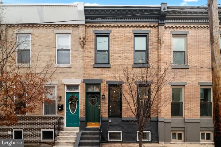 This one-of-a-kind two-story home seamlessly blends modern luxury and timeless charm. It underwent a full interior renovation in 2021, but it’s far from cookie cutter. Pops of color and character are observed at every turn, from a charming vestibule adorned in tile, to exposed beams and brick throughout. Nestled in the heart of the highly sought-after Dickinson Narrows, this home is situated just steps away from one of Philadelphia’s most frequented green spaces, Dickinson Square Park. As you step inside, you'll be greeted by stunning hardwood floors that flow throughout the home, adding warmth and elegance to every room. The living space boasts breathtaking exposed brick walls, some painted in a crisp white and others in a deep green hue, perfectly complementing the character and history of this unique residence, the bones of which date back to the 1920’s. The open-concept layout on the main floor creates an inviting atmosphere for both everyday living and entertaining. The kitchen is a chef's dream with top-of-the-line appliances, sleek countertops, functional yet aesthetically pleasing built in shelving, and ample storage space. Large windows allow natural light to illuminate the interior, highlighting its beautiful architectural details. Upstairs, you'll find three well-appointed bedrooms with plenty of closet space. Both full bathrooms, one in the main hallway, and the other directly off the primary, are tastefully designed, boasting regal finishes. Your primary suite features a spacious bedroom with high ceilings and large windows that flood the room with natural light. Exposed brick walls add a touch of rustic charm, while built-in drawers and his + hers closets ensure plenty of space for all your wardrobe needs. The ensuite bathroom boasts double sinks and a walk-in shower, offering both convenience and elegance. Your fully finished basement offers the ideal flex space for various activities and needs. Beyond this versatile area, you'll find an oversized LG washer and dryer, a sump pump, and ample storage opportunities. To enhance your daily convenience, a thoughtful half bathroom completes this functional and well-designed space. Outside, enjoy your own private backyard oasis – perfect for relaxing or hosting gatherings with friends and family. With this home’s prime location near parks, shops, restaurants, and public transportation options, 1645 South Orkney offers both convenience and tranquility. Don't miss your chance to own this exceptional property that truly captures the essence of Philly living. Available now. Schedule your tour today!