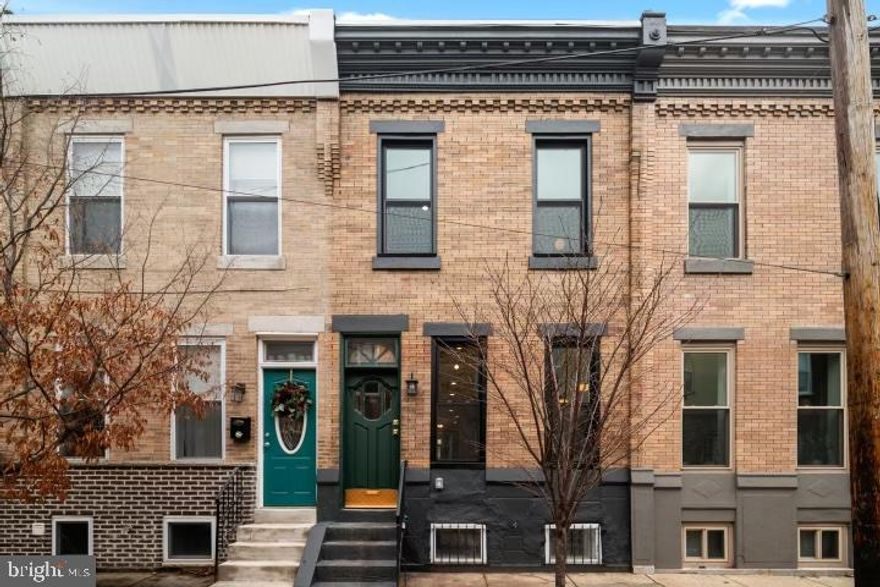 This one-of-a-kind two-story home seamlessly blends modern luxury and timeless charm. It underwent a full interior renovation in 2021, but it’s far from cookie cutter. Pops of color and character are observed at every turn, from a charming vestibule adorned in tile, to exposed beams and brick throughout. Nestled in the heart of the highly sought-after Dickinson Narrows, this home is situated just steps away from one of Philadelphia’s most frequented green spaces, Dickinson Square Park. As you step inside, you'll be greeted by stunning hardwood floors that flow throughout the home, adding warmth and elegance to every room. The living space boasts breathtaking exposed brick walls, some painted in a crisp white and others in a deep green hue, perfectly complementing the character and history of this unique residence, the bones of which date back to the 1920’s. The open-concept layout on the main floor creates an inviting atmosphere for both everyday living and entertaining. The kitchen is a chef's dream with top-of-the-line appliances, sleek countertops, functional yet aesthetically pleasing built in shelving, and ample storage space. Large windows allow natural light to illuminate the interior, highlighting its beautiful architectural details. Upstairs, you'll find three well-appointed bedrooms with plenty of closet space. Both full bathrooms, one in the main hallway, and the other directly off the primary, are tastefully designed, boasting regal finishes. Your primary suite features a spacious bedroom with high ceilings and large windows that flood the room with natural light. Exposed brick walls add a touch of rustic charm, while built-in drawers and his + hers closets ensure plenty of space for all your wardrobe needs. The ensuite bathroom boasts double sinks and a walk-in shower, offering both convenience and elegance. Your fully finished basement offers the ideal flex space for various activities and needs. Beyond this versatile area, you'll find an oversized LG washer and dryer, a sump pump, and ample storage opportunities. To enhance your daily convenience, a thoughtful half bathroom completes this functional and well-designed space. Outside, enjoy your own private backyard oasis – perfect for relaxing or hosting gatherings with friends and family. With this home’s prime location near parks, shops, restaurants, and public transportation options, 1645 South Orkney offers both convenience and tranquility. Don't miss your chance to own this exceptional property that truly captures the essence of Philly living. Available now. Schedule your tour today!