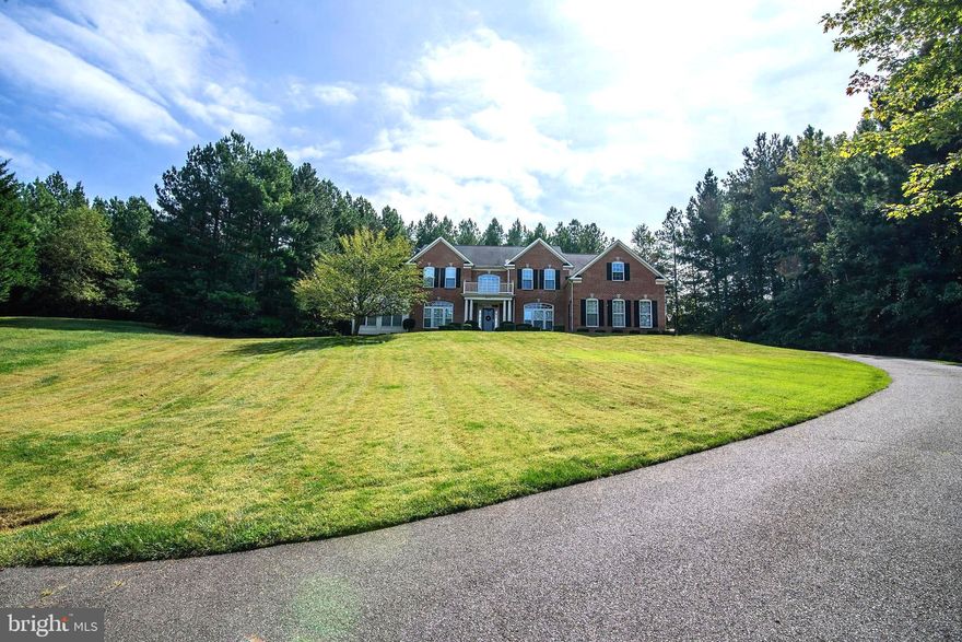 Stunning Double Wing Colonial on Almost 2 Acres.  Step Inside of this Beauty with Over 7500 SF.    Gorgeous Cherry Hardwood Floors on Main Level.  Two Story Foyer and  Double Staircases.  Main Level Boast Living and Dining Rooms With Cove Ceilings, Huge Solarium,  Private Study, Gourmet Kitchen is Huge and Has  Granite Countertops, Stainless Steel Appliances, Double Ovens, Cooktop,  Extra Large Island, and Gorgeous New Flooring.  Two Story Family Room With Stone Fireplace, and Large Rear Sunroom.  Upper Primary Bedroom is Spacious and Has a Sitting Room.  Primary Bath Has Separate Vanities, Jacuzzi Tub, and Water Closet.   All Bedrooms are Primary Size., and Have Huge Closets.  Newer HVAC,  New Garage Doors, Freshly Painted, New Carpet, New Flooring In Kitche, Sunroom, Laundry, Mud Room, and Butlers Pantry,  Surround Sound,  Mud Room and Main Floor Laundry.   Two Piece Crown Molding, Recessed Lights.   New Custom Brick Lead Walk to the Front Door.  Walkout Lower Level is Over 2500 Sf, is  Just Waiting on New Owner To Finish To Suit Their Style.  Backs to Large Trees for Privacy.  This is a Must See!
