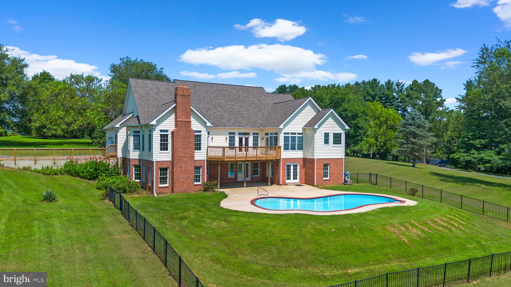 One-of-a-Kind 3-Acre Estate with Over 6,000 Sq Ft and Room to Expand
A blend of elegance and rustic charm, this spacious home of grace and grandeur welcome both fine living and the soulful simplicity of farm life—ideal for chickens, goats, and horses alike. Welcome to this extraordinary 5-bedroom, 3.5-bath estate with the opportunity to complete an additional two bedrooms, a den, full bath, and a loft on the third floor—featuring impressive 12-foot ceilings! The main level alone spans 2,900 square feet, thoughtfully designed for both grand-scale entertaining and comfortable everyday living.
Step inside to soaring ceilings and oversized windows that fill the home with natural light. The layout flows effortlessly from the formal dining room and great room to a chef’s kitchen outfitted with brand-new appliances, quartz countertops, custom cabinetry, and a generous island perfect for gatherings.
The spacious family room, complete with beamed ceilings and a brick fireplace, offers a cozy yet refined ambiance. Retreat to the luxurious primary suite with a private sitting room, spa-inspired ensuite bath, walk-in closet, and sweeping views of the surrounding horse pastures. Two additional large bedrooms, a Jack-and-Jill bath, and a convenient powder room complete the main level.
The fully finished lower level—offering more than 2,500 finished square feet—features full-size windows and three sets of French doors, creating a bright, open feel that rivals main-level living. Designed with entertaining in mind, this space includes another family room, dining area, game room and large bar area prepped for a full kitchen—ideal for hosting guests or creating a complete in-law suite. You'll also find a second owner's bedroom with walk-in closet, a full bath, additional bedroom, and a utility room.
Outdoors, a private pool, expansive deck, concrete patio, and a 31 x 22-foot barn significantly elevate the outdoor living experience. The property offers a taste of the countryside while remaining conveniently close to shopping, restaurants, and major routes—truly the best of both worlds. This exceptional property offers luxury, flexibility, and plenty of space (7,790 sq ft) to grow— A rare find!