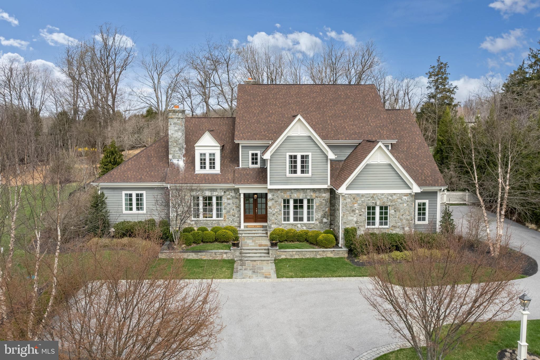 Nestled in the picturesque community of Riverwood, this impressive and stately home boasts design-inspired appointments throughout. A perfect escape from the everyday, this exceptionally upgraded home is sited and designed to blend privacy and nature, with amenities and convenience. Luxurious features include gleaming hardwood flooring, intricate custom moldings, soaring coffered ceiling, and a main level primary suite fit for royalty. A Chef inspired kitchen sure to impress adorned with professional stainless appliances, 6-burner Wolf gas range, wine chiller, ice maker, Sub Zero refrigerator, custom soft close cabinetry, oversized center-island, display cabinetry, and exquisite lighting. Enjoy your morning cup of Java from the adjoining breakfast area complemented with built-in seating. An adjacent two story great room highlights a coffered ceiling, built-in shelving and one of three fireplaces. Opposing formal living and dining rooms provide multiple entertaining spaces. The elegant floor plan flows seamlessly from formal to informal spaces, always keeping the tranquility of nature in proper view. Travel upstairs to find a welcoming second primary suite embellished with a lavish en suite bath and a large walk-in closet. Two additional en suite bedrooms with walk-in closets complete that upper level sleeping quarters. Downstairs, get ready for the big game or host a casual gathering in the expansive recreation room with a fireplace, graced with a full custom bar with a wine refrigerator, ice maker dishwasher and a full bath, an en suite bedroom, game room, and an exercise room. Entertain outdoors with a spectacular Flagstone custom patio, outdoor fireplace, and a stellar tree lined view. Come home to serenity, in a convenient location, with a retreat like feel, this is simply paradise!