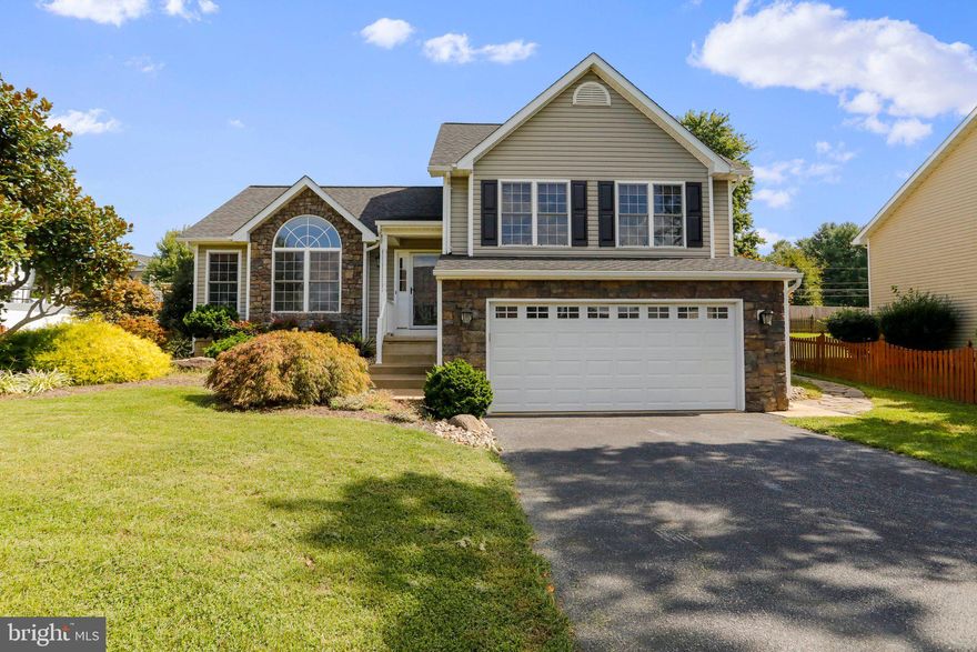 This attractive stone-front home with beautifully landscaped outdoor space is ready for immediate move in! At the end of the street, so no through traffic. Fully fenced backyard with deck, pergola, firepit, and storage shed. Trees and landscaping create privacy. Inside, you'll find hardwood floors and kitchen with stainless appliances and granite countertops. Family room has vaulted ceiling and gas fireplace. There are three beds and two baths upstairs, including primary suite with double sink, soaking tub, and walk-in closet. Two car garage and paved driveway provide plenty of parking options. Work from home using highspeed internet available through Comcast/Xfinity. Excellent location just minutes from downtown Charles Town and right off 340 for easy commuting! OPEN HOUSE MON 9/19 from 6-8 PM!