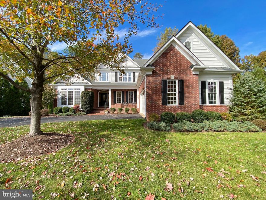 Gorgeous custom Dream Home located inside the premier luxury gated Fawn Lake Community of Fredericksburg!
A welcoming front porch enhances the charming exterior design. Inside, a two-story Foyer opens to a beautiful custom floorplan accented with gleaming hardwood floors, large windows offering plenty of sunlight, and beautiful details throughout. The grand two-story Family Room features a spectacular wall of windows offering incredible views of nature. 
The  Gourmet Kitchen with custom Cherry Cabinetry, granite countertops, and a large Butler's Pantry offers ample space for preparing meals, and entertaining.  An inviting Breakfast Room with access to the  amazing screened Porch, flows into a charming Family Room  with a cozy gas fireplace. 
The Formal Dining Room is perfect for hosting elegant gatherings.  A spacious main level Owner's Suite with double walk-in closets and luxurious Spa Bath with large soaking tub and tile shower offers abundant comforts to unwind and relax. 
A Guest Bedroom with an adjoining Full Bath serves as an optional Office.  The Laundry Room with built-in plenty of storage cabinets completes the main level. 
The Oak staircase leads to a spacious Loft for a multitude of flexible living options. Two gracious Bedroom en-suites  with Full Baths, plus a large unfinished space complete the upstairs.
With unlimited possibilities, the huge unfinished Basement offers plenty of space for future expansion  and storage! 
 The private backyard, which abuts to a wooded Conservation area, was designed for enjoying the beautiful sights and sounds of nature. 
Designed to maximize breathtaking outdoor scenery, the home is nestled on a deep  .64 Acre lot filled with mature hardwoods and lush landscaping. Perfect for taking in the beautiful sights and sounds of nature, the charming screened porch and large deck offer idyllic space for extended outdoor living and entertaining.  
An array of flowering shrubs and beautiful ornamental trees highlighting the manicured grounds. Sited in a desirable  established area, right in the heart of the community. Conveniently located playgrounds, the walking and biking path that leads to the pool, beach, tennis courts, and the Fawn Lake Country Club!

The grounds are easy to maintain with the in-ground irrigation system. 
**The beautiful Luxury Fawn Lake Community offers amazing amenities such as a boating recreational lake, beach, Arnold Palmer designed golf course, tennis courts, baseball and soccer fields, dog park, volleyball courts, walking trails, Community Club House, marina, fitness center, restaurants, Country Club, playgrounds, and so much more! Located in the countryside near the town of Fredericksburg, surrounded by park lands and only a few miles to the farm market, wineries, and award winning breweries!