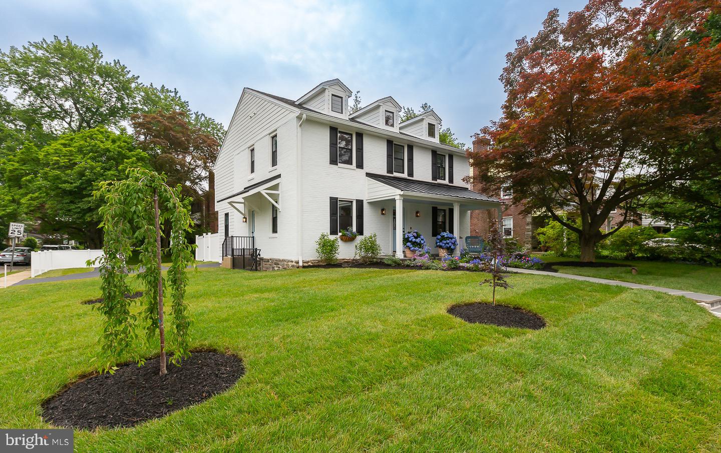 Welcome to this beautifully updated single family home in Lower Merion Township. Meticulously renovated by Pradelli Homes. This four bedroom, three full bath and 2 half bath home sits on a corner lot in a quant Main Line neighborhood just minutes from the city. From the moment you arrive, you’ll notice the attention to detail. A charming front porch covered in bluestone , bluestone walkway and professional landscaping are just the start. Enter through the front door and you’ll love the custom wallpaper in the formal dining space. Beautiful wide plank white oak floors throughout. The open concept living room and eat in kitchen are the perfect spot for family gatherings. The kitchen is an entertainer’s dream. White shaker cabinetry, Callacatta quartz countertops with a full slab backsplash, waterfall island, large farm sink, Serena and Lily light fixtures, and GE Café matte white appliances. The living room has floor to ceiling wainscoting and a gas fireplace with marble surround. From the eat in kitchen enter the fully fenced private backyard with paver patio. There’s plenty of storage in the spacious mudroom with built in cabinetry and bench seating. On your way to the second floor note the custom Dash and Albert runner in a fun stripe on the stairs. The large primary en suite boasts 12 foot ceilings, bathroom with double vanity and Carrara marble countertop and floors, shower with exposed shower system and glass surround. Fully outfitted custom walk-in closet. Charming Jack n Jill bedrooms with full bath. The Large fourth bedroom could also be used as an office space. Also on this level is a hall bath and laundry space with built in cabinetry. The fully finished walk-out basement with two large spaces and powder room adds an additional 600 ft.² of living space. The basement layout provides endless options. Playroom, guest space, bar, living room, gym, office space, home business. This home is just minutes from everything. Suburban Square, Center City, restaurants, parks, and entertainment. Located in the coveted Lower Merion school district. With approximately 3000 sq feet of finished living space this home has everything. New mechanicals, tankless water heater, new plumbing, new electrical, new windows, new doors, new appliances, James Hardie siding, two HVAC zones, new insulation throughout, new roof, professional landscaping, hardscaping, custom woodwork, new flooring throughout, custom stair runner, custom wallpaper, crown molding, designer light fixtures. Do not miss this opportunity to live in a fully updated home with meticulous finishes in an unbeatable Main Line location.
