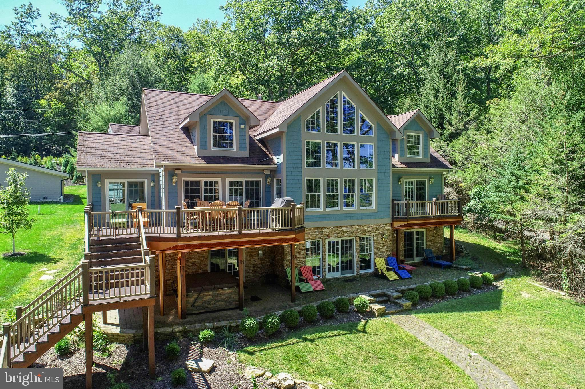 Unmatched EXCEPTIONAL Lakefront Living – 6 Bedrooms | 7.5 Baths | Tucked Among the Pines
Discover a rare opportunity to own a true lakefront, lakeview gem—this 5,400 sq ft, 6-bedroom, 7.5-bath home that is nestled among tall pines on an exceptional lot that sits unusually close to the water’s edge. With peaceful views across a quiet cove and expansive open-water vistas from the oversized covered dock, this property offers a front-row seat to lake life at its absolute best.
Inside, the soaring vaulted wood ceiling living room, with a beautifully done stone fireplace, welcomes you with warmth and charm. Paired with a dramatic wall of glass that frames a tranquil view of the sparkling water beyond. It’s a space that brings the outside in and makes every season feel like a postcard.
The open layout continues into a spacious dining area and a gorgeous kitchen with soapstone countertops, viking stove, a wood-topped island, a large walk-in pantry, and a bright breakfast room surrounded by windows. Step out to one of two lakeside decks—one perfect for outdoor dining, the other for grilling—all just steps from the shoreline.
The main-level primary suite features its own private deck overlooking the lake, a walk-in closet, attached bath with a large shower. Upstairs, three generously sized bedrooms each have their own ensuite bath, extra large closets—two with built-in window seats ideal for curling up with a book and taking in peaceful lake views.
The lower level is designed for comfort and fun, offering a family room and recreation area, custom built-in cabinetry with a wet bar, a wood burning stone fireplace, another spacious, private bedroom suite with a walk-in closet, and walk-out access to the lake. Multiple closets for maximum storage. A full bath is conveniently located off the mudroom. Step outside to relax in the hot tub overlooking the lake. The bath is perfectly situated for rinsing off after a soak in the hot tub or a swim in the lake.
Additional highlights include three tankless water heaters, in-floor radiant heat in the lower level, two mechanical rooms, and ample storage space. The newly redone laundry room is a dream come true with a deep utility sink, generous folding and hanging space, and two sets of full-sized stacked washers and dryers.
Above the laundry area, a wonderfully private upper-level suite offering a cozy bedroom, sitting area, and a stylish full bath with a walk in tiled shower—perfect for guests, extended family, or an office retreat.
Outside, enjoy your evenings around the lakeside fire pit for s'mores and stories, or relax on the oversized covered dock that puts you right on the water. This is not just lakefront—it’s EXCEPTIONAL lakefront, with the house sitting closer to the shoreline than most, offering rare intimacy with the lake itself.
An attached two-car garage, paved driveway, and ample parking make a year-round access a breeze- whether you're seeking a full-time residence or a vacation getaway.
Private. Peaceful. Perfectly positioned—this lake home is an extraordinary retreat that must be experienced to be fully appreciated. Call today for your private tour!
5 Bedroom Rental Projection...$97,835 - $112,440. 6 Bedroom Rental $110,035 - $126,940, 6 Bedroom would require a sprinkler system to be installed.