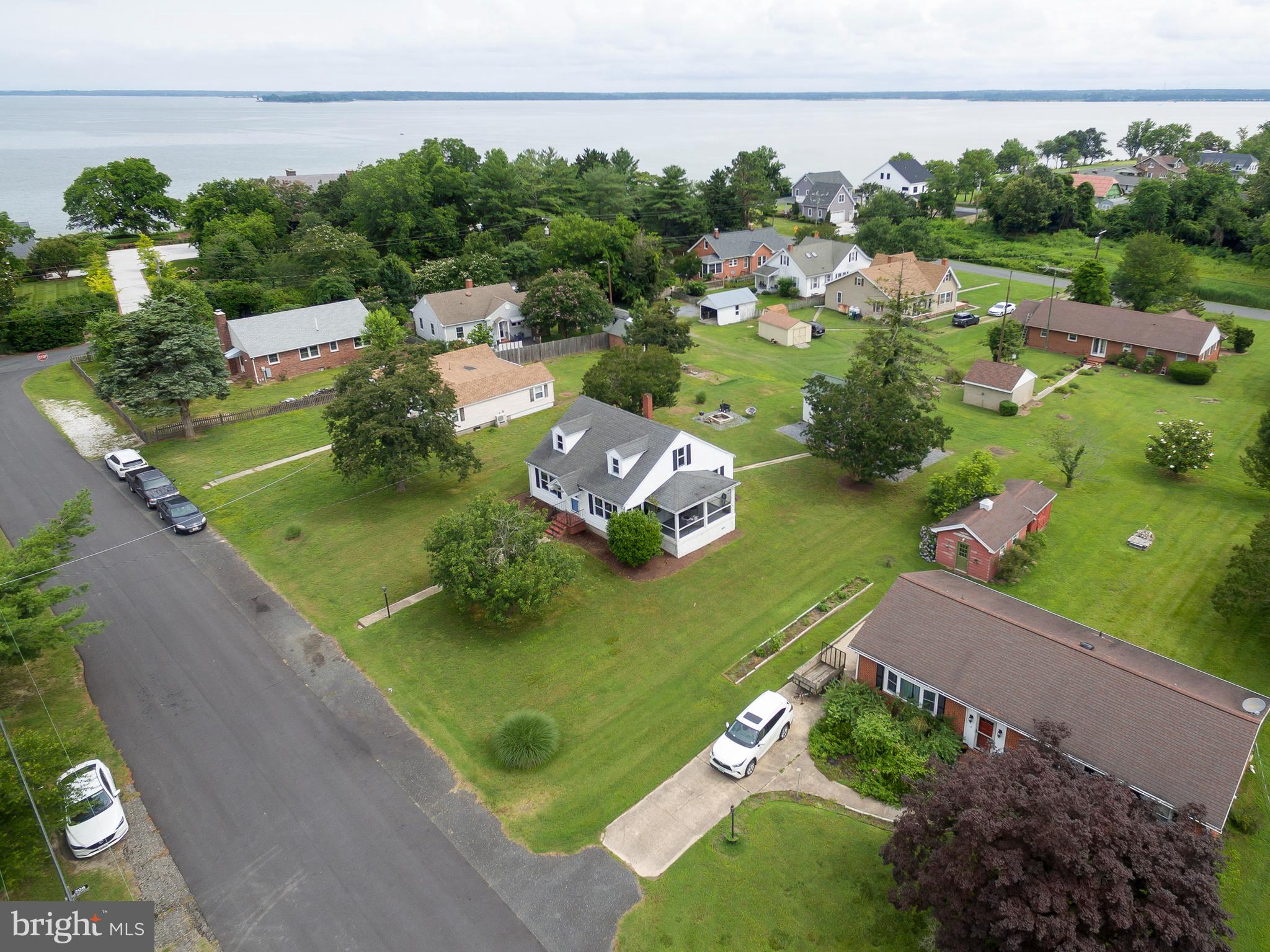 This Home offers a Great Opportunity to live 1/2 Block from the Choptank River and close to all that Cambridge has to offer but no City Taxes. A walk up attic that has the potential of being 2 additional Bedrooms and a 2nd Bath with views to the river. A large lot with a rear alley access to your Detached Garage and Workshop. A solid , Well Built Home that will make a wonderful Weekend Escape or your Forever Home. Priced to Sell with wonderful hardwood floors and a nice screened porch accessible from the Kitchen or Living Room.